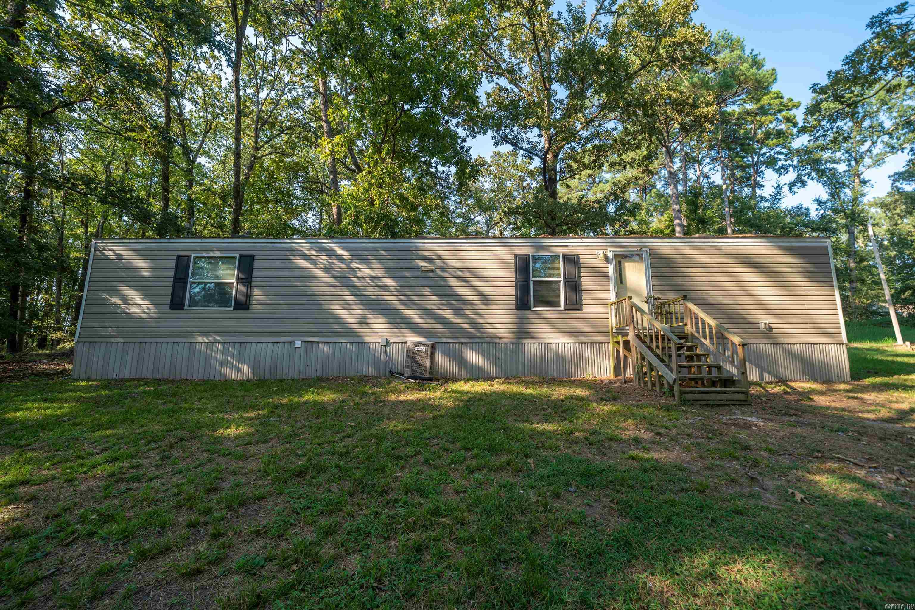 Affordable 2-Bed, 2-Bath Mobile Home Surrounded by Nature Looking for peace, privacy, and a budget-friendly place to call home? This 2-bedroom, 2-bath mobile home sits in a quiet area surrounded by woods, offering a relaxing setting without breaking the bank. The home itself could use a little TLC, but it has everything you need at an affordable price. With its low cost and private location, this property also makes a great investment opportunity—perfect for a long-term rental. Schedule a showing today and see the potential for yourself!