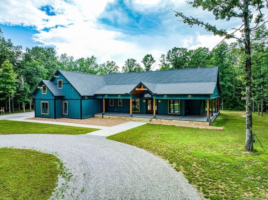 A stunning 4,621 sq ft custom home just minutes from downtown Mountain View, AR, nestled on over 7 private acres. This 5-bed, 3.5-bath estate features high-end finishes throughout, including vaulted ceilings, wide plank vinyl flooring, and a rock fireplace. The gourmet kitchen boasts Thor appliances, quartz countertops, and a massive island, while the butler’s pantry and mudroom add function and style. Enjoy over 5,000 sq ft of covered porches, an outdoor kitchen, firepit, and a 4-car garage with bonus workout space. The luxurious master suite features 22’ ceilings, a fireplace, spa-like bath, and a spacious walk-in closet. Additional highlights include a game room, home office, 6-zoned HVAC, security system, whole-home water treatment, and generator hook-up. Located just 1.5 miles from White River public access, this exceptional property combines luxury, space, and proximity to town—an incredibly rare find. Call today to schedule your private tour.