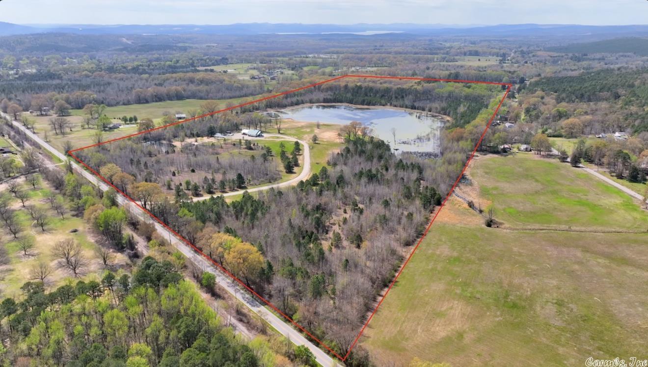 This beautiful land is off Highway 300. It is approximately 9 miles from Hwy 10 and Chenal Parkway. This Property has Both Cleared and Wooded Areas and Includes 2 Ponds and a Morgan Barn that has been turned into a barndominium. The barndominium is 3 bedroom and 2 full baths. it is 2500 square feet and so beautiful. There is a a home pad that has been built for a large home, overlooking the large pond. There is a septic system that could service multiple homes or a large house. This Land is Ideal for Your Own Private Estate or Residential Development. Wildlife and Peace and Quite are Abundant.