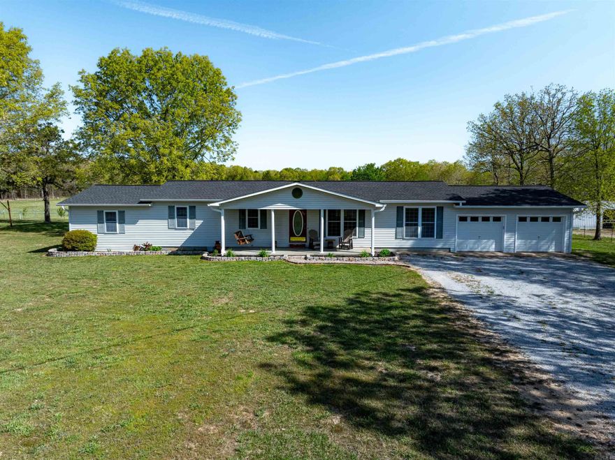 Country Comfort Just Outside Strawberry, Arkansas  This charming 3 bed, 3 bath home sits on 1 acre in a peaceful rural setting, just minutes from Strawberry. With a roof under 2 years old and a brand-new back deck, it’s move-in ready!  Inside, enjoy a spacious living room that flows into a large dining area and kitchen with a breakfast bar, eat-in space, and views out the kitchen window. Fresh paint and some new flooring add a clean, updated look. The split floor plan gives privacy while keeping everyone close.  Two guest bedrooms are near full baths, and the primary suite features a private entrance, walk-in shower, double vanity, and closet inside the bathroom.  This home has central heat/air, an outdoor wood-burning furnace to help with utility savings, and wall propane heaters for backup. The propane tank is owned and will stay. It’s currently on well water but can be connected to county water.  Outside you’ll find a two-car garage, garden area, lawn shed, and space for the kids or pets to roam. A utility shed and chicken coop are on-site (coop will go with sellers). The new back deck is perfect for grilling or relaxing and taking in the country view.