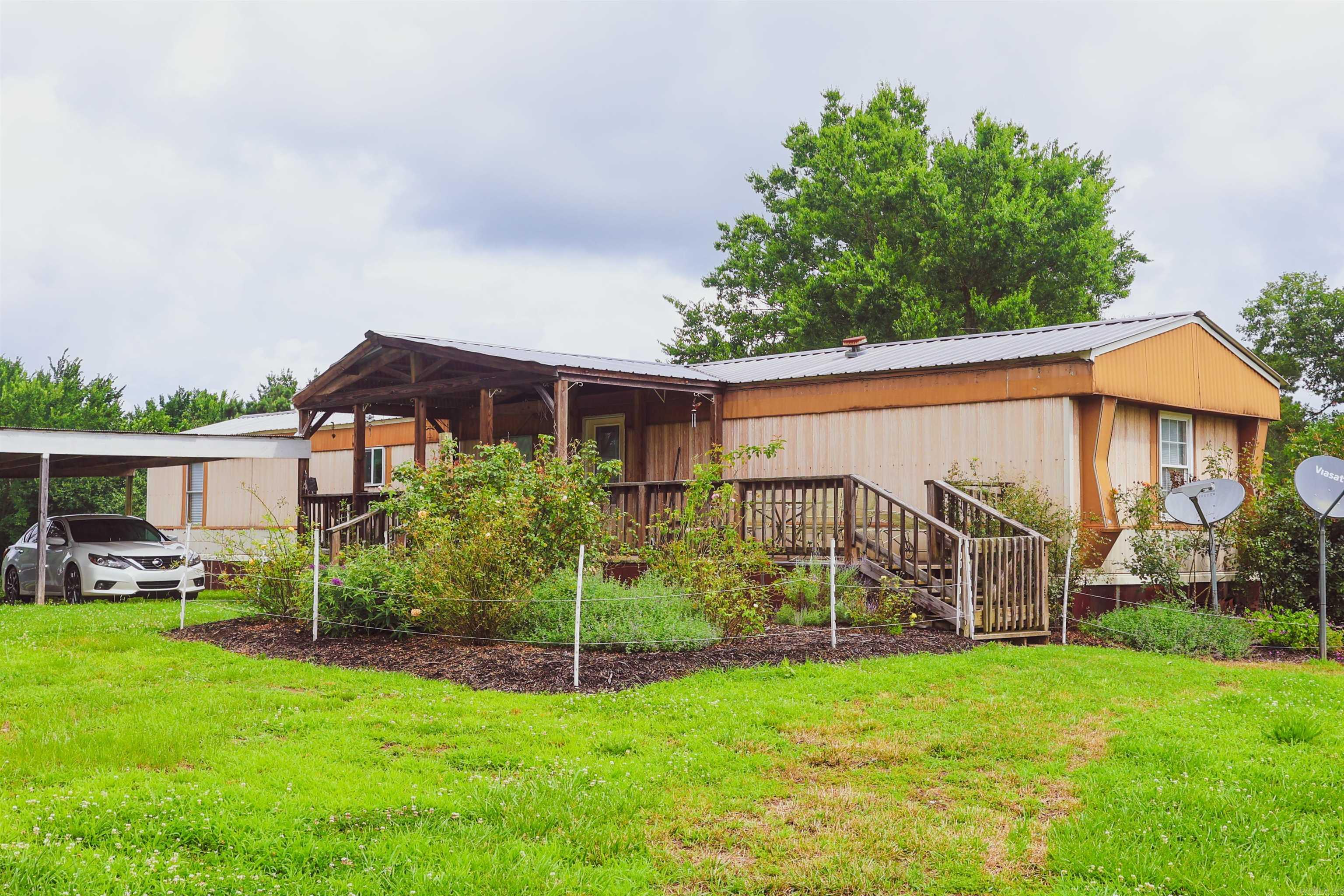Versatile 17± Acre Property with Two Homes, Shop, and Fencing – Ideal for Multi-Family Living or Livestock Discover the perfect blend of country living and functional space with this 17± acre property, fully fenced and cross-fenced, ready for livestock, multiple families, or your next investment opportunity. The property features two well-maintained mobile homes—each offering 3 bedrooms, 2 bathrooms, covered carports, and spacious front porches perfect for relaxing and taking in the surroundings. Additional highlights include an older shop for storage or projects, and ample open land to expand, garden, or raise animals. Whether you're looking for compound living, guest accommodations, or a hobby farm, this property is a rare opportunity with room to grow.