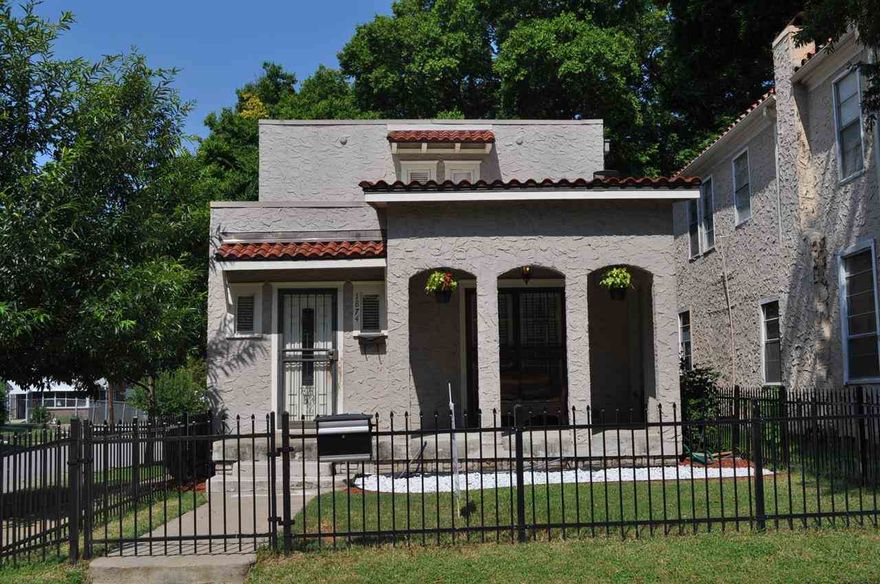 Charming Mediterranean  Villa with designer colors! This lovely home has a nice quaint front porch. Large living room, a bonus room that may be used as an office with hardwood floors throughout.  Arched doorways, separate dining room, a 2nd full bath on lower level.  A cozy kitchen with lots of storage and a pantry.  The master ste has good size closet and bath has been updated, laundry room security system and sprinkler. There is very nice fully fenced back yard.