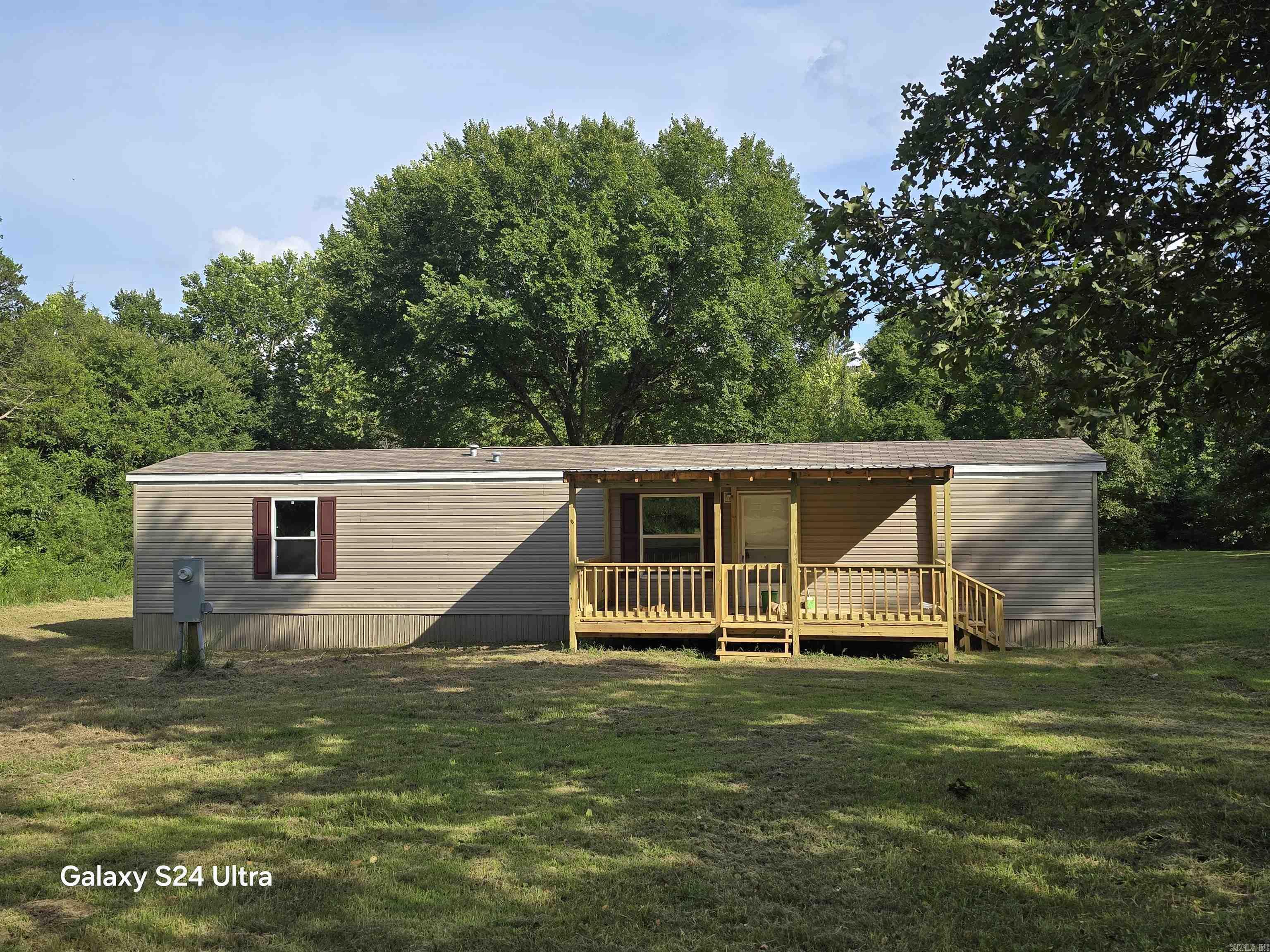Nestled in the foothills of the Ozark Mountains in a little town called Sidney in Arkansas you will find this hidden gem. You will enjoy appx 240' of private landowners only lakefront property in your own little cove on 1+/- Acre of land with a brand new 2 bed/2 bath manufactured home that has never been lived in! From the open concept floor plan to the modern color scheme this efficient, all electric and well laid out 16' x 40' Champion manufactured home will no doubt provide warmth and coziness in it's small space. The owner just had a small front deck and back deck added on! When you walk out of the back door the land gently slopes to your own private cove on Deer Run Lake. Deer Run lake is a private, landowners only, no wake lake only enjoyed by Deer Run Property owners! The lake is known for it's excellent bass, crappie and catfish fishing and is a very sought out lake to own property on! To find a beautiful, new, lakefront property for under 150K is rare so do not wait on this one! Schedule your showing TODAY!