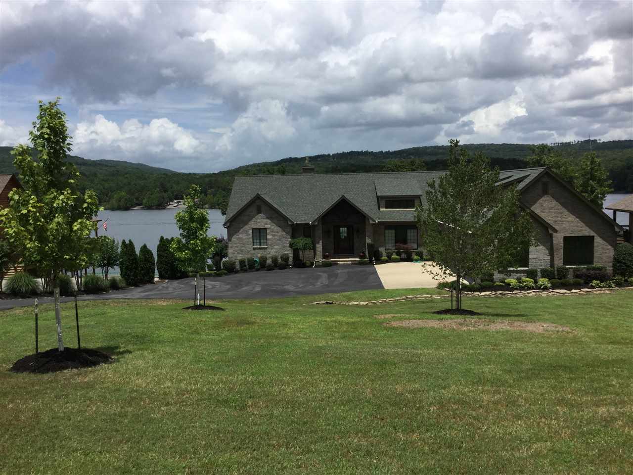 Lakefront & Lake View w/2 Boat slips, both have lifts (1 for pontoon & 1 V-Hull)  Located across from Hill Creek Marina in one of the most desirable fly-in subdivisions (private community airstrip) & community boat ramp. Dellos Clemmons built this magnificent lake house, everyone who knows Mr Clemmons understands the detail he puts into his homes. Nothing was spared. ICF WAS USED TO BUILD THE WALK-OUT BASEMENT (www.icfbasement) (6" concrete walls). Dues appear on tax bill as special Assessment.