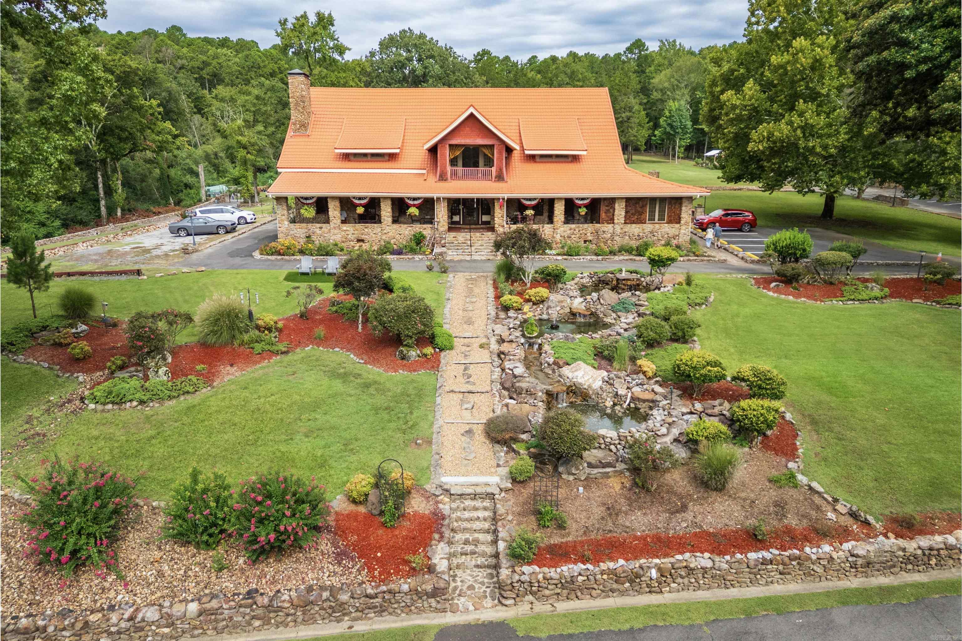 Don't miss the chance to own this Prime Hospitality Bed and Breakfast a 1910 Craftsman manor home completely restored to classic elegance in 2005,with many new updates in 2024. Situated on a 5,5 acre estate which borders Hot Springs National Park in the Foothills of the Ouachita National Forest, and Home to Oaklawn Horse Racing, where tourism thrives. This Boutique Bed & Breakfast offers five deluxe suites. Flat screen TV's with YouTube TV, WIFI and DVD movie library. Spa tubs, fireplaces, 1000 thread count sheets, fluffy robes and more. The Five acres offers over 5 acres to explore, gardens, swings and hammocks, fire pits and firewood stone fireplace and patio with patio lights for tranquility and relaxing. Business opportunity to host weddings up to 100 people. Honeymoons! Family Reunions, Retreats, Weekend Escapes, Adventure, Romantic Getaways, Birthdays, Road Trips and more!