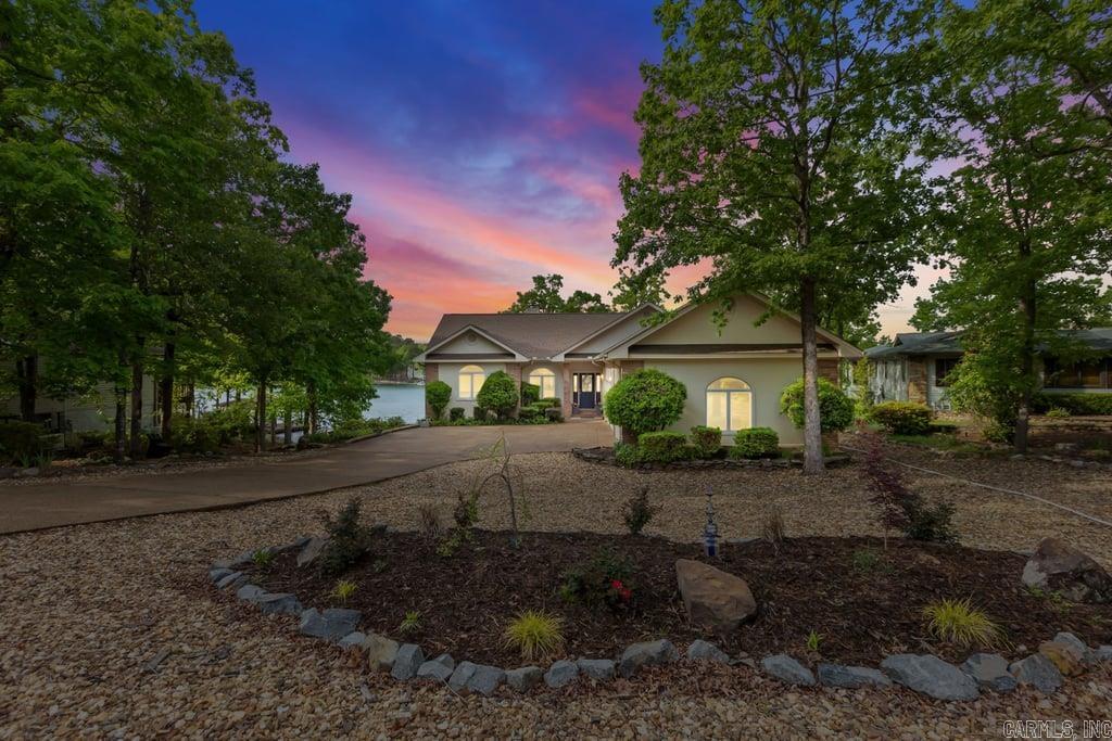 Welcome to your lakeside paradise! Nestled on the shore of Lake Balboa, this magnificent 4 bedroom, 2 1/2-bath home boasts lake living at its finest. As you step inside, you're greeted by an elegant interior featuring a spacious living area adorned with a quartz surround fireplace, perfect for cozy evenings. The gourmet kitchen is a chef's delight, equipped with a convection oven, all newer appliances, ample cabinetry, and a large island. The stunning master suite offers a tranquil retreat, complete with a spa-like ensuite bathroom with slipper tub and walk-in shower. 3 additional bedrooms provide plenty of space for family and guests, while the large laundry room and extra storage ensure convenience and organization. Step outside to your private oasis, where a Flagstone Path leads you to your double boat dock, ready for endless water adventures. Relax and unwind in the hot tub as you soak in the breathtaking scenery surrounding you. With a three-car garage and a host of luxurious amenities, this lakeside haven offers the ultimate blend of comfort, convenience, and sophistication. Don't miss your chance to call this dream home yours! OPEN HOUSE SAT MAY 4! 11am-3PM