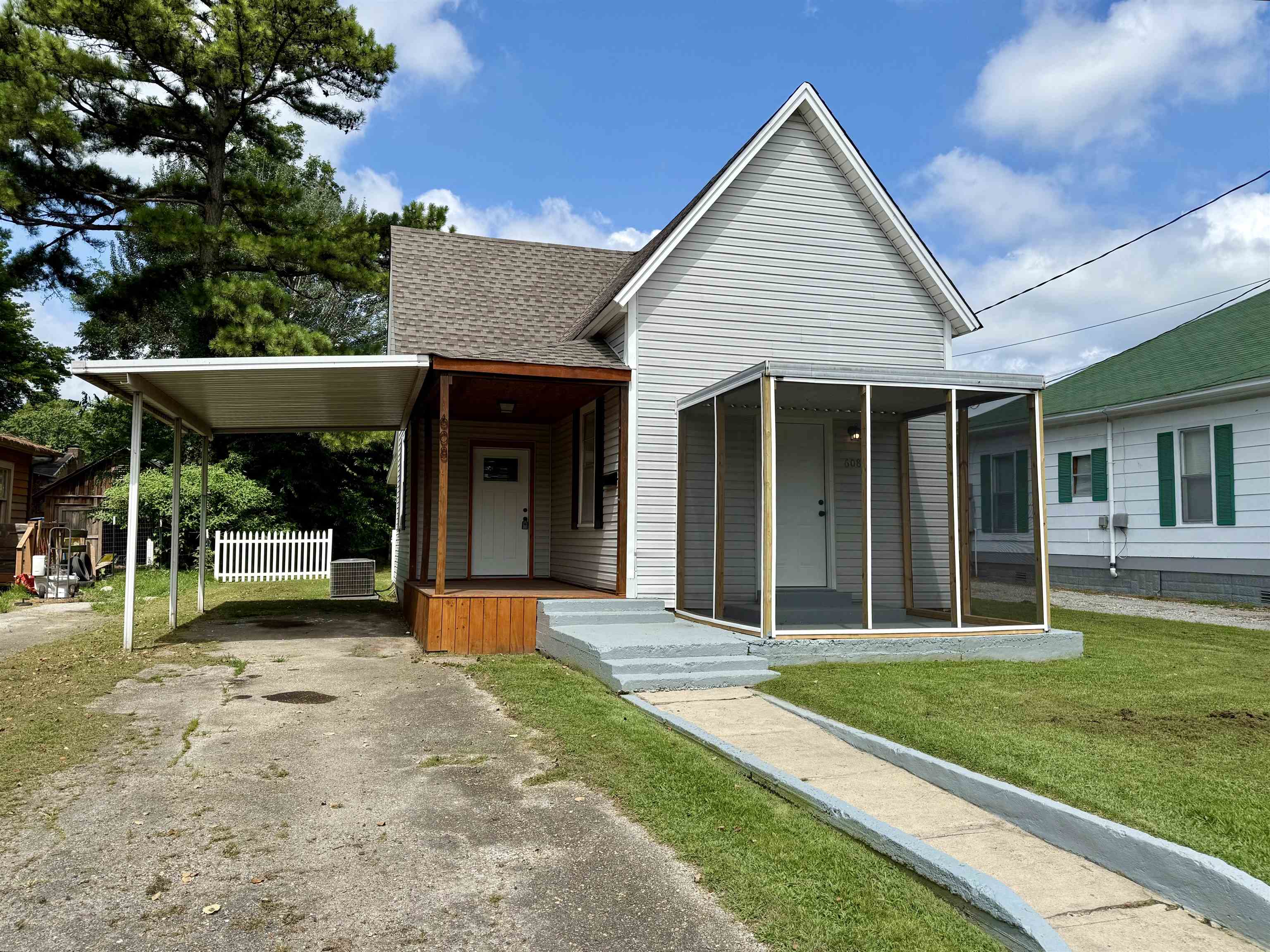 Allow me to introduce you to this bungalow-style home offering timeless curb appeal and a welcoming covered front porch. The property features a spacious carport and a generous lawn, ideal for outdoor living or future landscaping visions. With its inviting accented entry and screened-in porch, this cozy retreat is perfect for anyone seeking comfort with character. Located just minutes from nearby amenities and positioned for convenience ā itās a gem waiting to be discovered. Inside this bungalow-style retreat you will discover an interior with timeless touches. The kitchen features warm wooden cabinetry, sleek stainless steel appliances, and a window-lit layout perfect for casual cooking or cozy entertaining. The modern bathrooms features a contemporary shower and large bathroom vanity with cabinets.