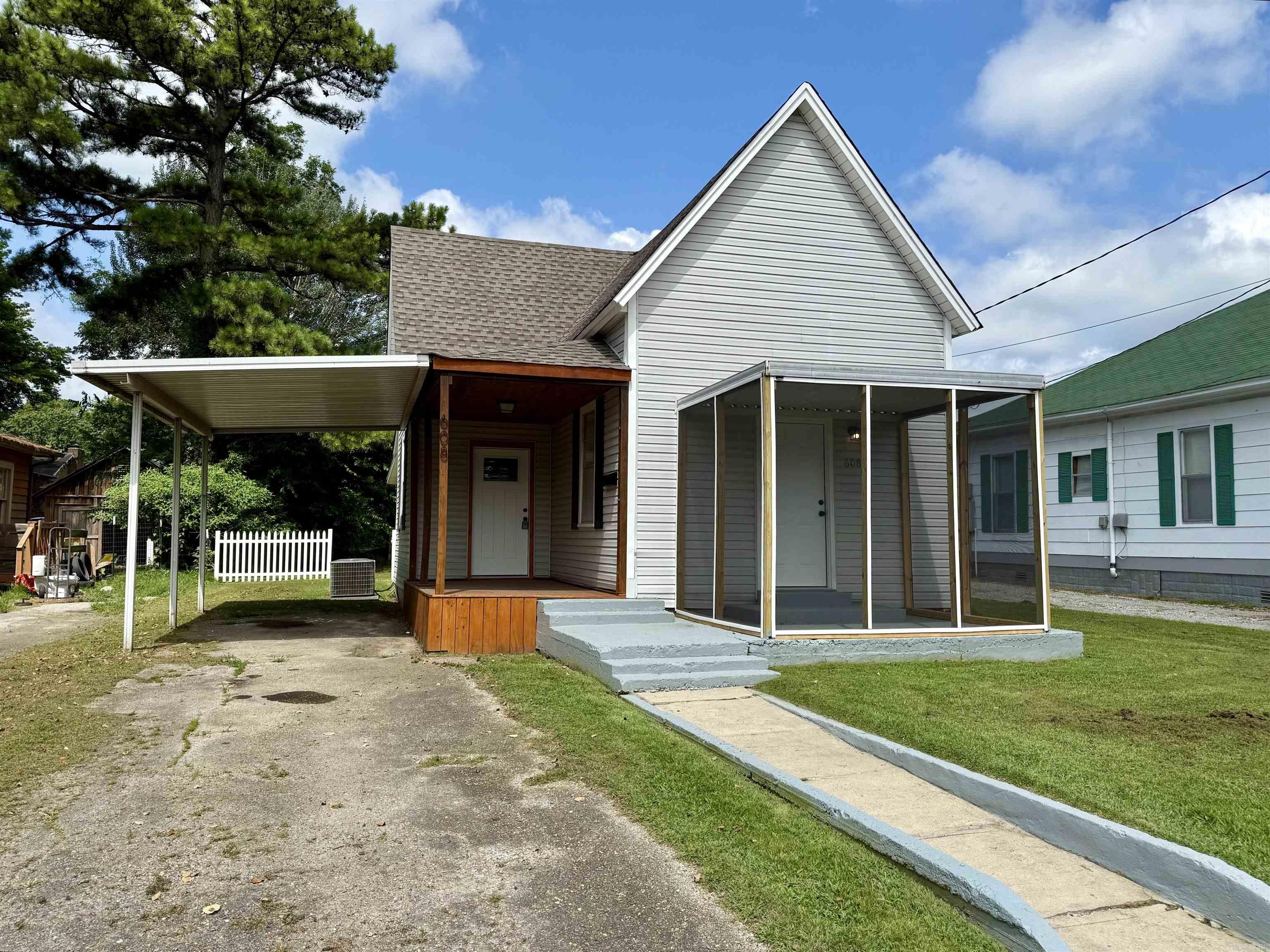 Allow me to introduce you to this bungalow-style home offering timeless curb appeal and a welcoming covered front porch. The property features a spacious carport and a generous lawn, ideal for outdoor living or future landscaping visions. With its inviting accented entry and screened-in porch, this cozy retreat is perfect for anyone seeking comfort with character. Located just minutes from nearby amenities and positioned for convenience ā itās a gem waiting to be discovered. Inside this bungalow-style retreat you will discover an interior with timeless touches. The kitchen features warm wooden cabinetry, sleek stainless steel appliances, and a window-lit layout perfect for casual cooking or cozy entertaining. The modern bathrooms features a contemporary shower and large bathroom vanity with cabinets.
