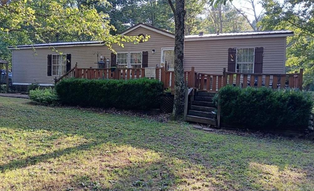 This is Beautiful acreage with a creek in the back. A hunters paradise with deer, turkey, and occasionally bear have been spotted nearby. A large portion of the property is wooded with road frontage and owners would consider subdividing. The mobile home is in good shape structurally with a brand new metal roof. The owner has taken well care of this place. Though this is rural there are fire hydrants present, and county water. A gravel road that borders the eastern boundary which leads to a 90 foot waterfall with a cool body of water at the bottom. This place makes you forget about the world while it brings back memories of when life was much more simple. All while only a few miles from civilization