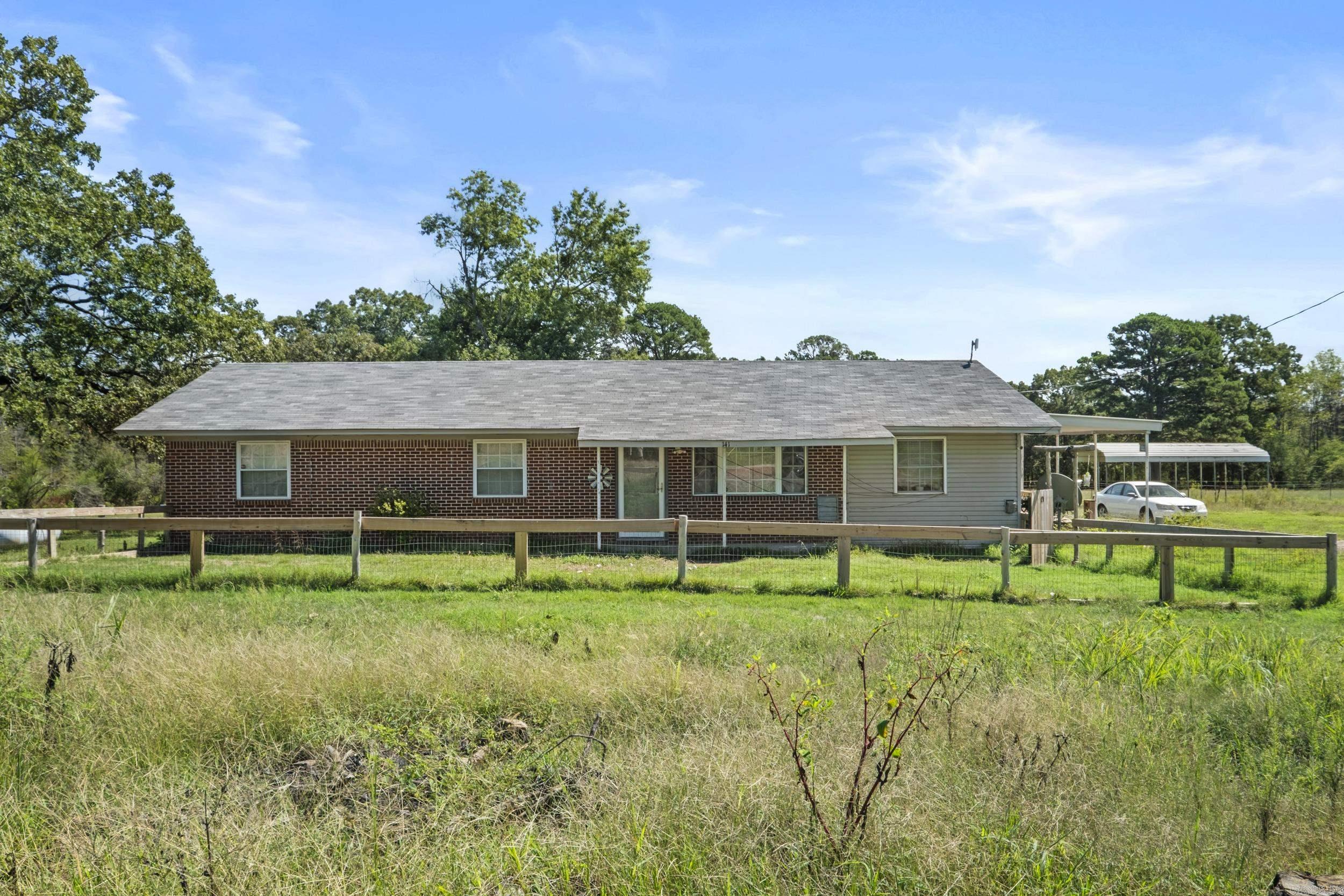 This home sits on approximately 5 partially fenced acres, offering the perfect setting for a mini farm or just enjoying the peace and privacy of rural living. New roof (2022) and whole house and carport Generac generator for peace of mind. Inside you'll appreciate updates including newly sheetrocked interior and a new stainless steel range, refrigerator, microwave, and washer/dryer that will convey with acceptable offer. The detached 2-car garage provides plenty of storage while the separate RV/Parking cover is ideal for extra vehicles and equipment. With open land, room for gardens, animals, and outdoor hobbies, this property is full of possibilities. Mineral rights do not convey.
