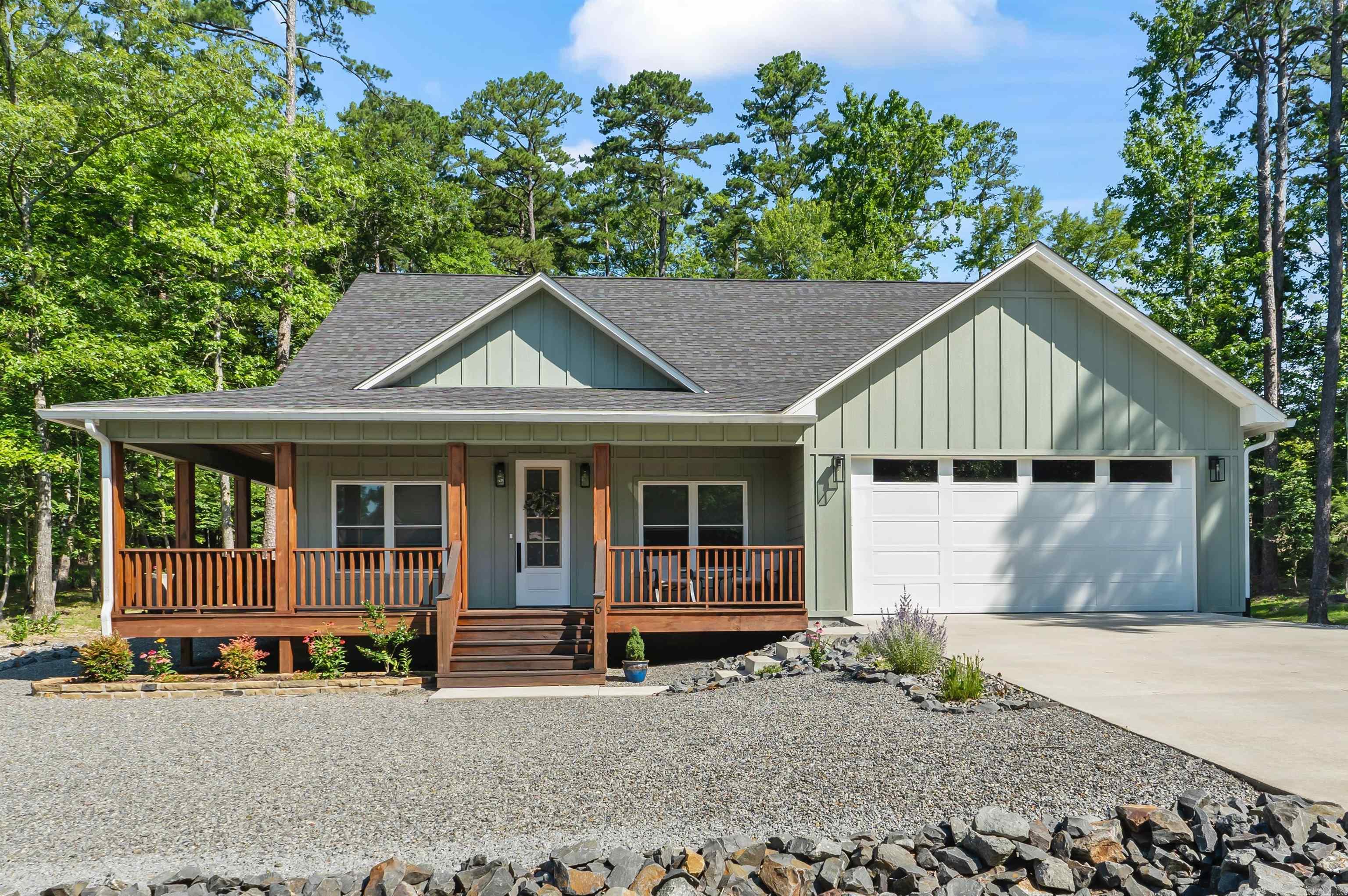 This gorgeous farmhouse design features an open floor plan with an incredible kitchen, complete with a large island and custom solid wood cabinetry throughout. Enjoy nature with front, back, and side covered porches, and slate rock path leading to a concrete pad for seating around the fire pit. This home comes with numerous extras, including a 26kW automatic gas generator, buried gutter drains, leaf-filtered gutter covers, a walk-in pantry, a mudroom, a large two-car garage, a beautifully landscaped yard, and storage galore.