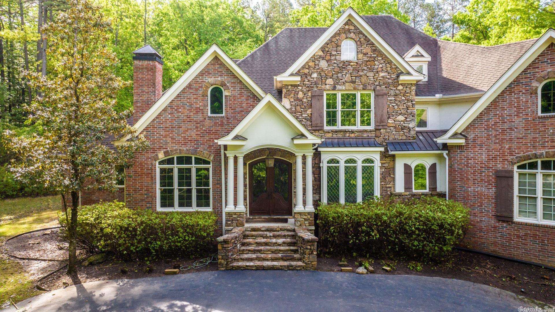 Welcome to this stunning 4 bed, 4.5 bath home situated on 5 acres of serene, wooded land in the highly sought-after gated community of Chenal Downs. This luxurious home boasts a gourmet kitchen which features top of the line Viking appliances including a built-in refrigerator which all convey with home. A wet bar on the way to the formal dining and living rooms. The master suite is a true oasis with a luxurious en-suite, heated tile and more. The main level includes a library and large family den both with a fireplace with glass inserts. Upstairs includes 3 bedrooms each with its own full bath a craft room, second living area and large open entertainment area. It has a huge amount of floored attic space. Back patio looking out into the woods and a 3-car garage to house all your toys. Home being sold as-is. New appraisal available upon request listing below appraised value. No SPD available. Roof and master shower will be replaced within 30 days.