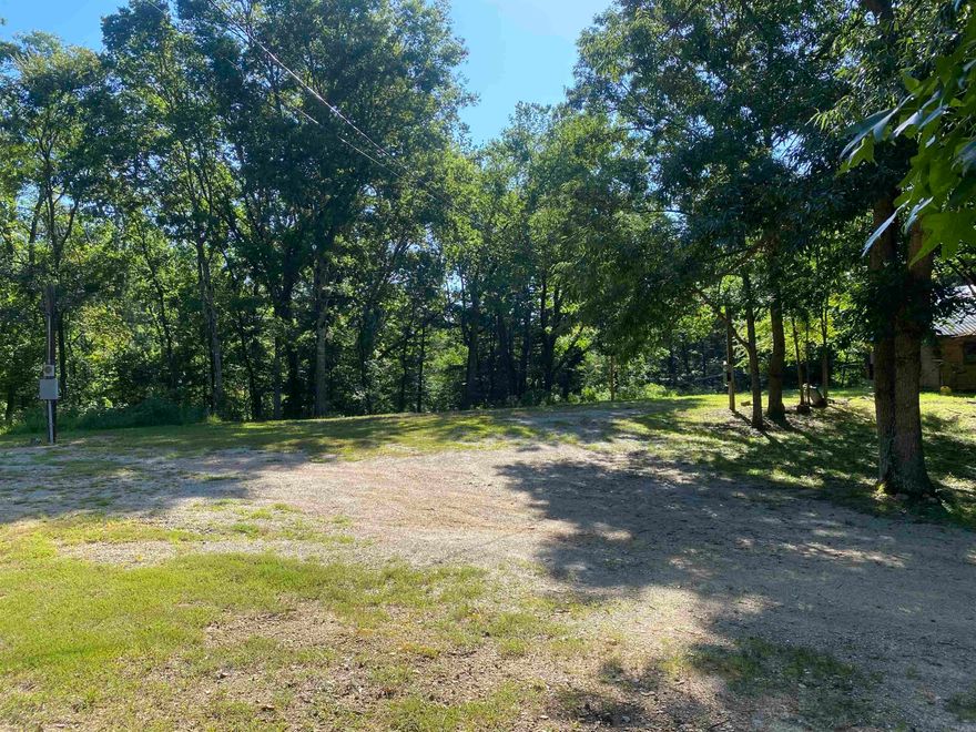 Here's what you have been looking for!  This lovely 6.64 acre parcel located a few miles from town and close to Lake Ouachita!  You can launch your boat in about 5 minutes from Dusty Trail.  The property is ready for you to build or move your new home on site.  There are 2 wells, 2 septics along with power already here!  If you prefer rural water, the box for the meter is located right on Dusty Trail and can be hooked up to your place. A fenced garden spot, currently full of flowers, is ready for you to produce whatever you choose to grow. The original farm house is still standing!  It could be refurbished, if that is in your wheelhouse. There is a wet weather creek toward the north side and tons of mature trees of all kinds. Don't miss out on this wonderful property!