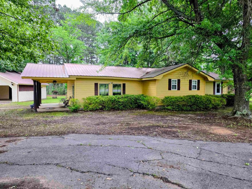 Ideally situated in the Woodlawn School District, this property is a rare find for those seeking both comfort and capability. The entire property is fully fenced, framing a beautiful wooded setting that includes a large detached carport/workshop. The shop and covered storage area are an added bonus for your outdoor toys and tools. Inside, the home stays perfectly tempered year-round thanks to a newly installed HVAC system. Highlights include a functional kitchen with ample cabinetry, cozy living spaces with built-ins, and a private, shaded backyard. The Homestead Credit covers all of the Real Estate Taxes as well!  Exceptional utility meets a prime location!