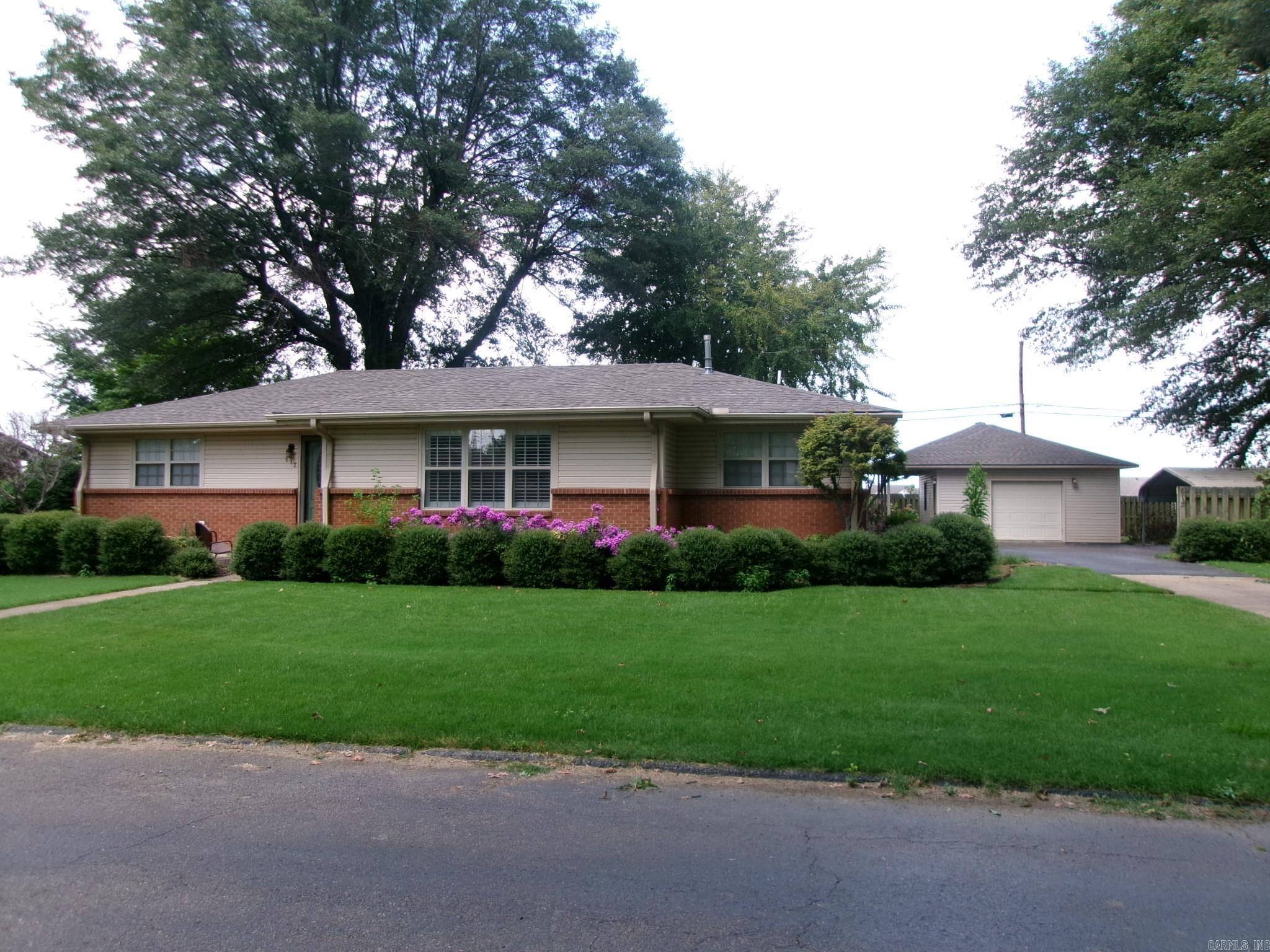 2 Bedroom, 2 Bath 1509 sf well maintained home with beautiful landscaped yard with sprinkler systen. The home has updated kitchen and bathrooms including tiled walk-in shower. Home has large living area with hardwood floor floor and fireplace. Home also has a storm shelter, shop with lean-to for boats, mowers and ATV's. Home is located less than 5 minutes from BIC School. This home is move-in ready. Must see to appreciate.