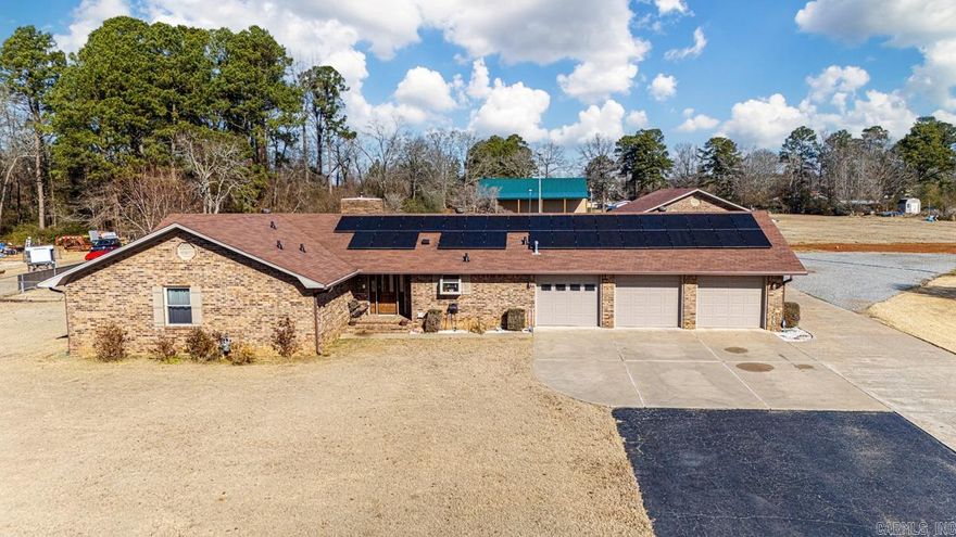 Absolutely fantastic opportunity on a terrific home full of bells & whistles! Almost 4 1/2 flat, cleared acres of land, including large, fenced back yard. Sellers spent $180,000 remodeling this all brick 1-level home 3 years ago! Massive kitchen w $40,000 worth of custom cabinets, plus quartz countertops & high-end appliances. Huge great room., big utility room, private office. 2 car attached garage is 30' deep w storage/shop area. 2nd free-standing matching brick garage/shop is 30'x40' w high ceilings, 1/2 bath, washing machine, sink and heated & cooled room. 3rd new metal 40'x50' barn w 20' ceilings for RV & all the toys! Beautiful lawn. Solar panels are paid for so VERY low utilities! Hot tub on patio, wood burning Buck Stove, new windows, 2 new water heaters, updated baths w custom walk-in shower & Jacuzzi air jet tub. 2 septic tanks, dump for RV.  Very close to Elem & Middle schools.