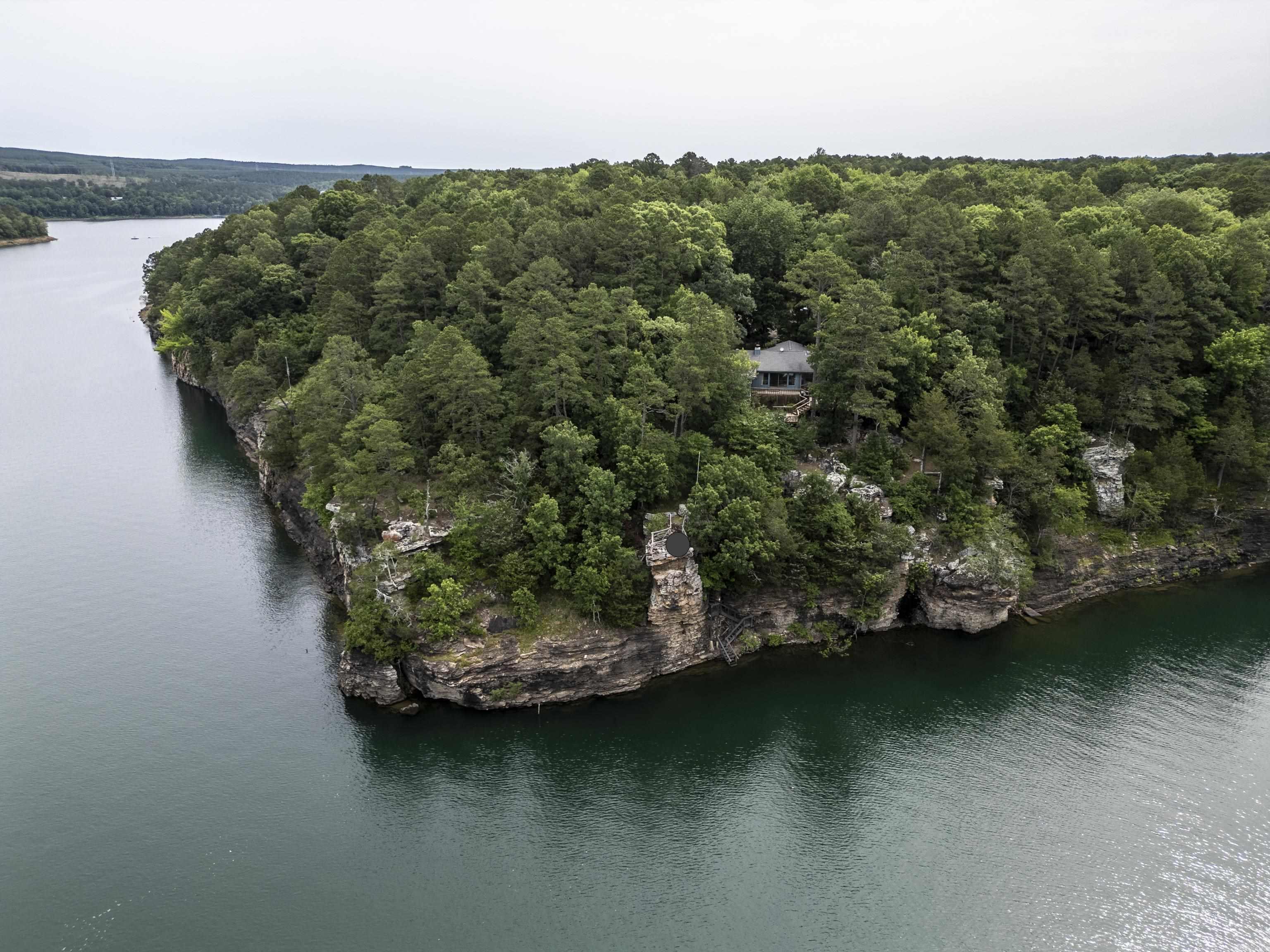 MOTIVATED SELLERS - BRING ALL OFFERS! Price reduced over $100,000. Nestled atop a rugged cliff overlooking the serene expanse of GREERS FERRY LAKE, this enchanting home embodies the epitome of lakeside living. Large picture windows overlooking the lake, inviting the beauty of the outdoors to spill effortlessly into the interior spaces. You will find large Anderson windows providing the best views! Features 3 bedrooms, 3 baths, large renovated kitchen and so much more. You will love be surrounded by towering pines and lush foliage, this idyllic retreat offers a sense of seclusion and tranquility, yet is just a short distance from all the amenities and attractions that the area has to offer. Whether you're seeking a peaceful retreat or an entertainer's paradise, this lakefront home is sure to exceed your every expectation, offering a rare opportunity to experience the beauty of nature in its purest form. This lakefront retreat is for you! Call for a personal tour and see for yourself!!!