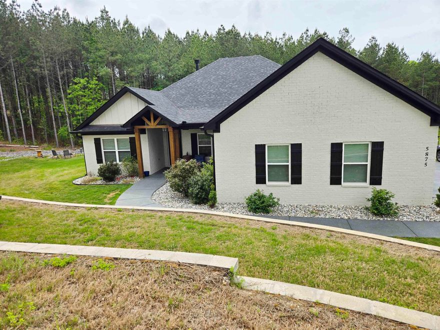 Beautiful one-level home on 2 private acres offering 4 bedrooms, 3 full bathrooms, and a dedicated office—conveniently located for commuting to Hot Springs, Little Rock, or Benton. Open-concept layout with tall ceilings, abundant natural light, beautiful flooring, and a brick fireplace with custom built-ins. Kitchen features a large island, granite countertops, stainless steel appliances, and custom cabinetry. Spacious primary suite includes dual vanities, soaking tub, and tiled walk-in shower. Covered back deck overlooks wooded acreage with custom stone fire pit and professionally terraced landscaping. Additional features include oversized heated and insulated garage with workspace and special coating on driveway and sidewalk. Agents see remarks and documents for more details on updates.