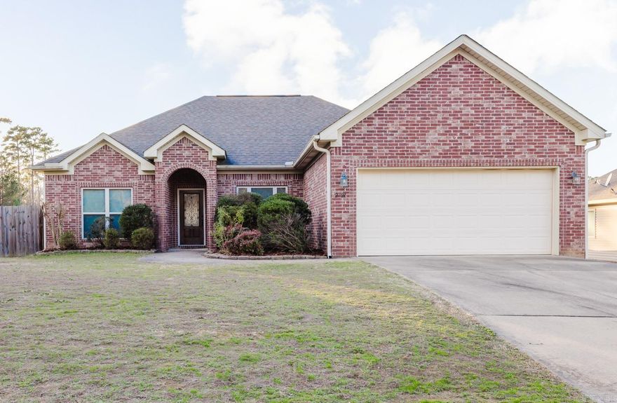 Move-in ready and beautifully maintained, this 3-bedroom, 2-bath home is located in desirable Springhill Village within the Bryant School District. The spacious living area features a cozy wood-burning fireplace. The kitchen offers an abundance of cabinetry with granite countertops and stainless steel appliances. Large primary suite.  Primary bath features a double vanity with a soaker tub and separate shower. There are 2 guest bedrooms separate from the primary.  Step outside to enjoy the fenced-in backyard with a covered back deck for outdoor dining or unwinding year-round. This home combines comfort, space, and a great location.....ready for you to move right in.