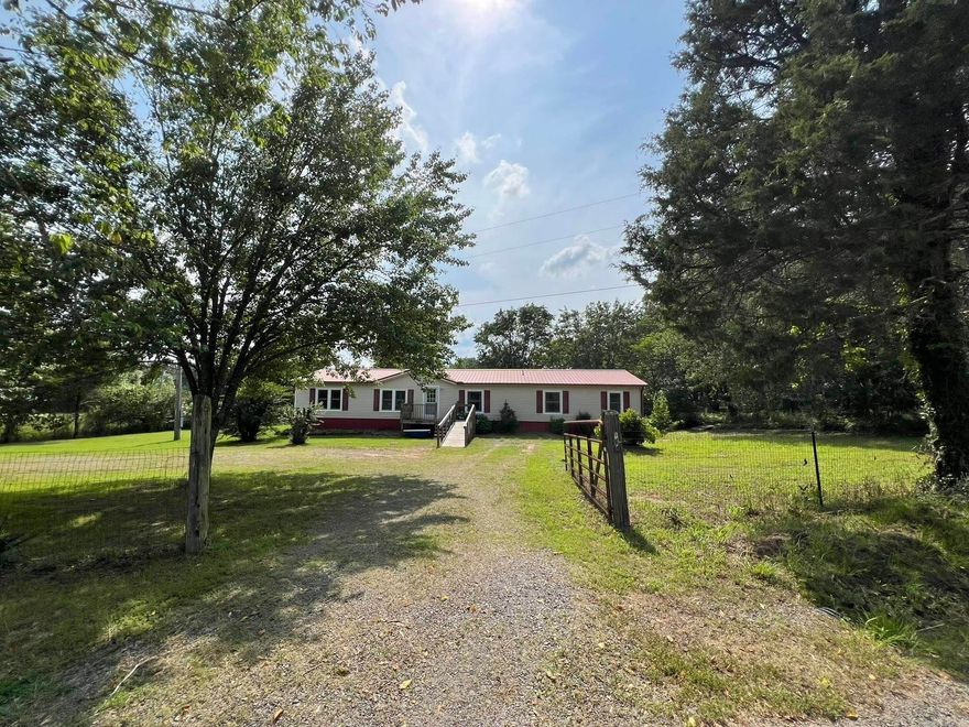 This well-maintained home on over 3 acres is a hobby farmer's dream. There is a durable hog pen located at the very rear of the property, along with a substantial building near the front edge of the rear that was formerly used for goats--I am thinking it could also be a chicken mansion! The home is surrounded by several mature trees. The covered back deck is a great place to relax after a hard day working the land. The property has a long metal shop/storage shed and an in-ground storm shelter. Inside, you will notice many updates: New Windows/Doors 2024, HVAC/Metal Roof 2018, Dishwasher 2023, Refrigerator 2022, Guest shower remodel 2025. With 3 full baths, 4 bedrooms and two living areas, there is room for everyone. Agents, please read remarks concerning financing and other important details.