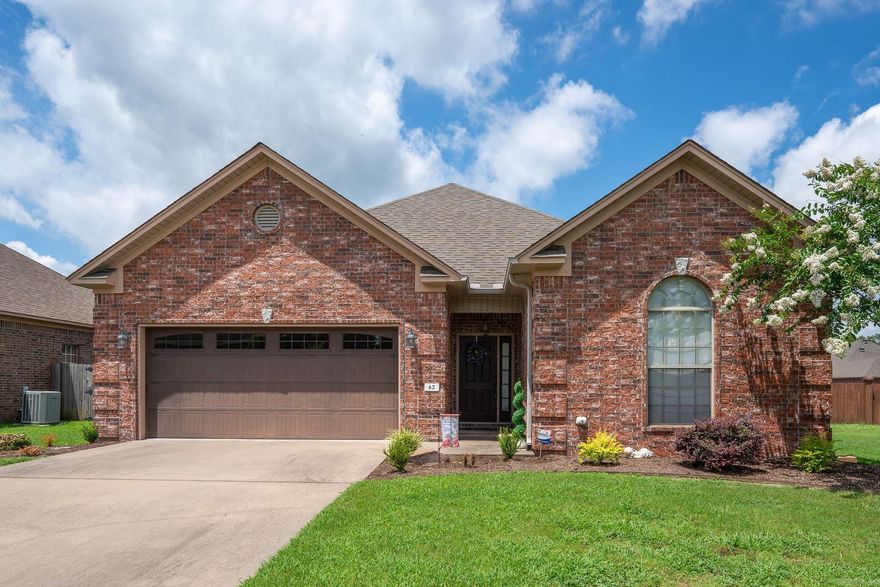 Beautiful All-Brick Home on Spacious Double Lot! This well-maintained home sits on a rare double lot with a huge fully fenced backyard—perfect for outdoor living, pets, and entertaining. Inside, you'll find a warm and inviting layout featuring rich laminate flooring, elegant crown molding, and a cozy gas fireplace as the centerpiece of the living room. The kitchen boasts stained wood cabinetry, stainless steel appliances, ample counter space, and a functional layout ideal for any home chef. With a 2-car garage, generator, fresh landscaping, and great curb appeal, this home offers comfort, space, and style in a desirable neighborhood. Conveniently located near shopping, dining, and schools, this home is move-in ready and full of charm! Don't miss this opportunity!