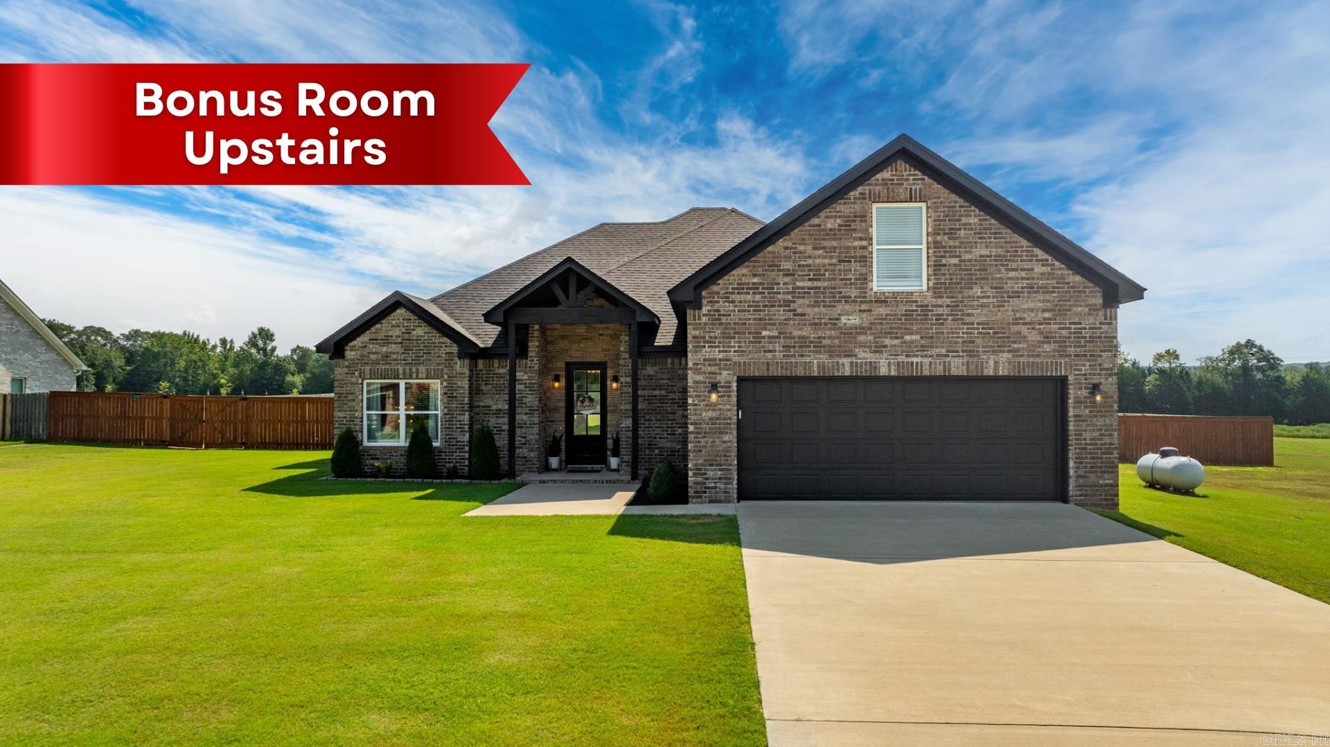 Beautiful newer home on a spacious 1-acre lot offering both comfort and style! This 3-bedroom, 2.5-bath home includes an upstairs bonus room—perfect for a 4th bedroom, playroom, home office, or guest space. The open-concept layout creates an easy flow between the kitchen, dining, and living areas, centered around a stunning fireplace that adds warmth and charm. The custom kitchen features sleek quartz countertops, a large island, stainless appliances, and a walk-in pantry with ample storage. The primary suite offers a relaxing retreat with a dual-sink vanity, soaking tub, and separate tile shower. Thoughtful touches throughout include luxury vinyl plank flooring, beautiful fixtures, and plenty of natural light. Enjoy outdoor living on the covered patio, with plenty of room to roam or entertain in the large backyard. Located in a quiet setting but still convenient to town, this one checks all the boxes!