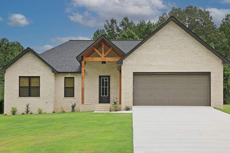 Elegance and fine craftsmanship describe this 4 bedroom 2 bath home perfectly. Built with all of the amenities of a high-end custom, this is NOT a standard spec house! Quartz countertops throughout, and wood-look tile completes the cozy feel in this very upscale new construction. Builder has installed high-end LG appliances, including refrigerator, microwave drawer, 5 burner custom gas stove for the chef in the family, and dishwasher. All cabinets and drawers are soft-close throughout the home. Primary suite flows from bedroom into bath and custom shower, then into closet and lastly an amazing laundry room with tons of storage. Across the hall is a huge walk-in pantry with extra room for crafts and big container storage. 3 large guest bedrooms on the opposite side of the home share a custom bath with double vanities, and the hall has an extra large closet for any additional storage needs. Beautiful back porch overlooks the woods behind.