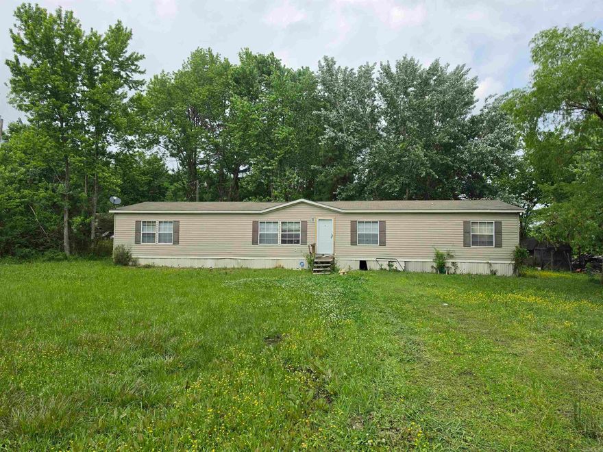 This huge 4-bedroom double wide home offers plenty of space and comfortable living on a full 1-acre lot. The standout primary suite features a large ensuite bathroom with double sinks, a relaxing soak tub, a walk-in shower, and a generous walk-in closet, perfect for a true retreat. The kitchen is a cook's dream with tons of cabinetry, a large island for prep and gathering, and a convenient walk-in pantry. Also enjoy cold nights with the woodburning fireplace. The layout flows well for both daily living and entertaining. The home sits on a full acre, giving you room to garden, add outdoor features, or simply enjoy some privacy. It’s in good condition and doesn’t need major work; you can move in right away and make improvements gradually as you go, turning it into exactly what you want over time. Cash or conventional financing only. No owner financing or FHA/VA. Survey on MLS. Sold as-is