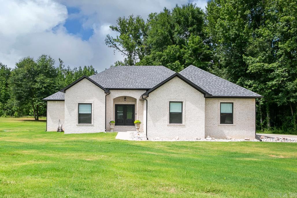 Introducing this beautiful 3 bedroom, 2.5 bath home built in 2023, offering 2060 sq ft of living space on a spacious 1.40 acre lot. Double front doors open into the foyer and large living room with fireplace. Open concept plan, kitchen has island, double ovens, ice maker, custom cabinets with soft close feature and pantry. Wood look tile throughout - no carpet. Primary bedroom is separate from the other two, primary bathroom has walk in shower, walk in closet. Laundry room with sink. A peaceful retreat awaits outdoors on the covered patio that also has a fireplace. Small area fenced in with iron fencing for your pets. Side load garage, safe room/storm shelter. So many extras packed into this home! Don't miss the opportunity to make this beautiful property your own!