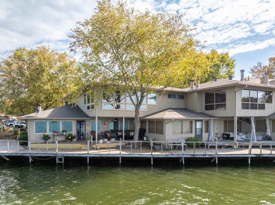 Stunningly Remodeled Lakefront Condo! Experience lakeside living at its finest in this beautifully renovated condo, featuring sleek finishes and contemporary design elements. Enjoy the warmth of a brand-new 50” Electric fireplace and the spaciousness of a vaulted ceiling with its 80 inch windmill ceiling fan while sipping on a cocktail served from your dry bar complete with color lit liquor cabinet and beverage cooler. This condo boasts all-new WIFI connected appliances and a smart HVAC system that you can control from your phone, ensuring your comfort no matter where life takes you. The large master bedroom leads you through a walk-in closet and laundry to a master bath that boasts an oversized shower as well as double sinks with a Bluetooth enabled light to drench you with your favorite music. Raise the automated power blinds because breathtaking panoramic views of Lake Hamilton await, offering spectacular sunsets right from your home. The complex includes a pool and a scenic boardwalk, with front patio space perfect for relaxation. Conveniently located near the bypass makes for easy access to downtown, Oaklawn Racetrack & Casino as well as many other area attractions