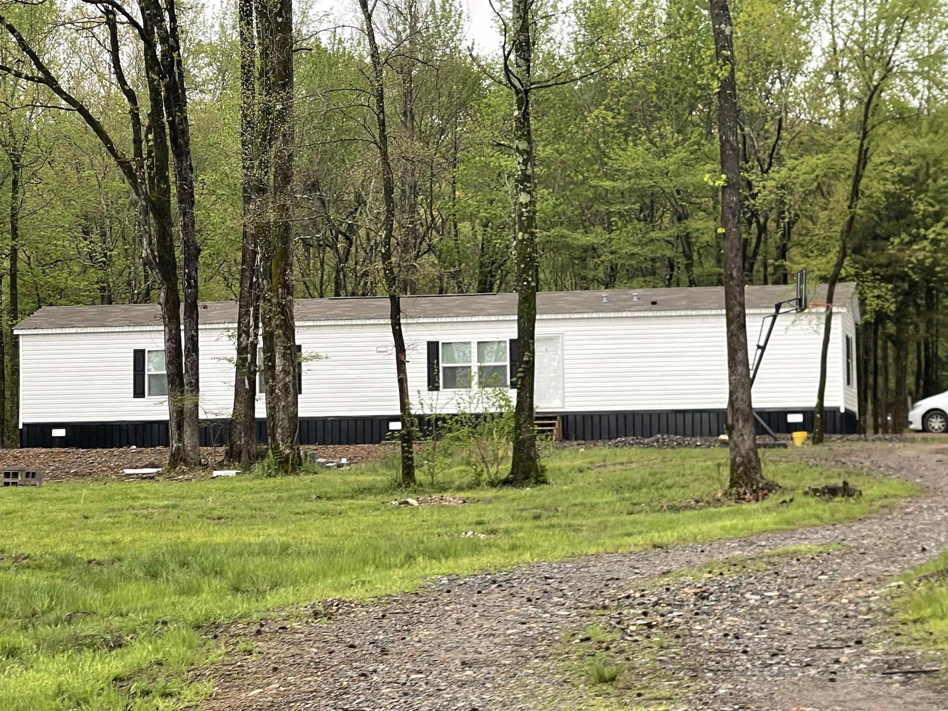 This 2024 Clayton River Haven is 1190 sq ft, 3 bedroom, 2 bath Mobile Home conveniently located on 3.18 acres just outside of Mena city limits. This Home has all of the upgrades, 2 X 6 exterior walls, OSB wrap, extra insulation, heat pump water heater, energy efficient windows, crown molding, tile shower in the primary bath, backsplash in the kitchen, and a farmhouse sink. It is solar panel ready. The House sits in front of a 24 X 32 Shop with a 12 X 32 lean to. The Shop has its own entrance.