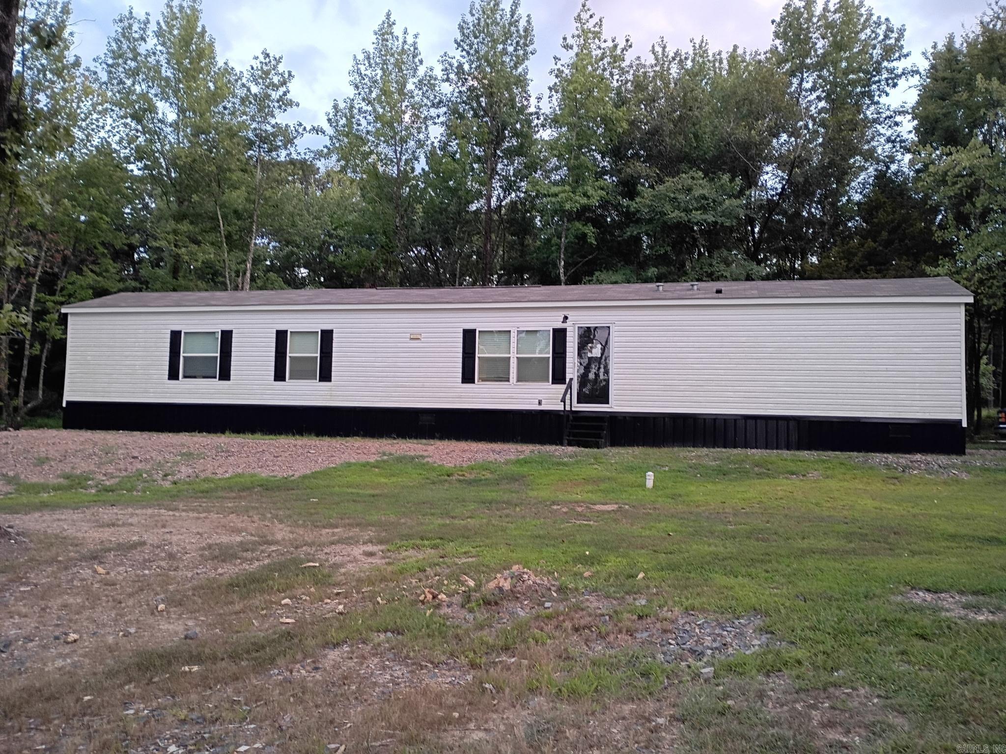 This 2024 Clayton River Haven is 1190 sq ft, 3 bedroom, 2 bath Mobile Home conveniently located on 3.18 acres just outside of Mena city limits. This Home has all of the upgrades, 2 X 6 exterior walls, OSB wrap, extra insulation, heat pump water heater, energy efficient windows, crown molding, tile shower in the primary bath, backsplash in the kitchen, and a farmhouse sink. It is solar panel ready. The House sits in front of a 24 X 32 Shop with a 12 X 32 lean to. The Shop has its own entrance.