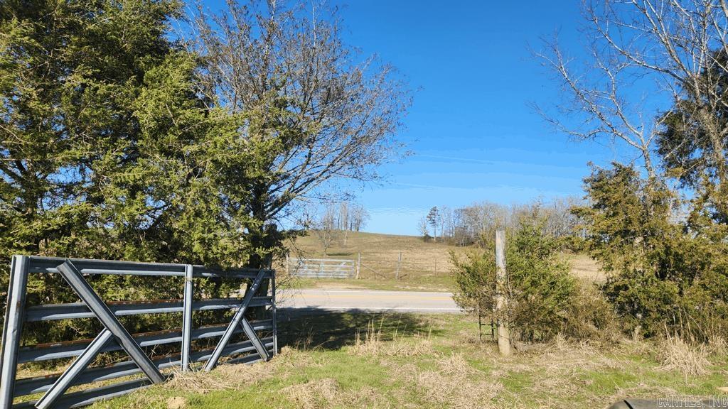 6.02 acres on Highway 298 east at Story AR. This unrestricted parcel has a building spot with a view of Sandlick Mountain. The meandering Cedar Creek runs along the south border. It is partially fenced. A well and septic will need to be installed. Power is along the highway. Mineral rights do convey. Only four miles to Irons Fork Recreational Area on Lake Ouachita or 3 miles to Cedar Creek ramp. And it is a short distance to Ouachita National Forest. Listen to the creek run, the frogs holler, and enjoy this peaceful setting. Call today for a showing.