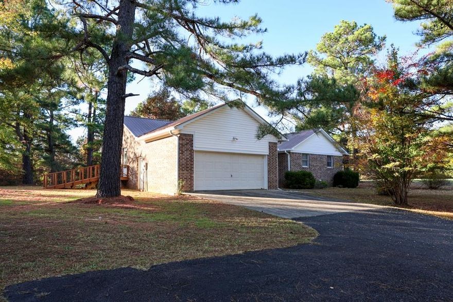 Nestled on 4.9 private acres on a peaceful dead-end road, this charming 1,745 sq. ft. country home offers the perfect blend of in-town convenience and country living in beautiful Izard County, North Central Arkansas. This low-maintenance gem boasts a durable brick exterior and a metal roof, featuring 3 bedrooms, 2 bathrooms, and an abundance of closet and storage space. The interior is designed for comfort and entertaining, highlighted by a large kitchen, a formal dining room, and a spacious living room. Step outside onto the expansive open deck, which is accessible from both the dining room and the master suite—an ideal spot for entertaining guests or simply winding down while overlooking your quiet, shaded yard filled with large trees. The property also includes all kitchen appliances, two metal sheds, a fenced garden area, and the benefit of paved road frontage in a great neighborhood.
