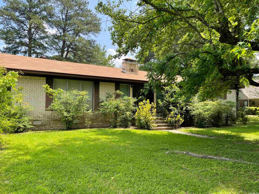 Brick 3 BR 2BA home in a great location!  Selling "as is" and no disclosure.  Home has been taken care of but does need updating.  Open floor plan with den/kitchen area.  Brick fireplace.  Kitchen has gas stove, dishwasher, oven, pantry, and refrigerator stays as does the washer and dryer in the separate laundry room.  (Disposal does not work.)  Bonus room would be great for either another living area or dining area.  There is storage galore in the hallway - one closet is even cedar lined! The double carport has storage off of it plus there is a shop/outside storage building which has no electricity but seller thinks is wired for it. CH/A was put in in 2015 and roof was installed in 2022.