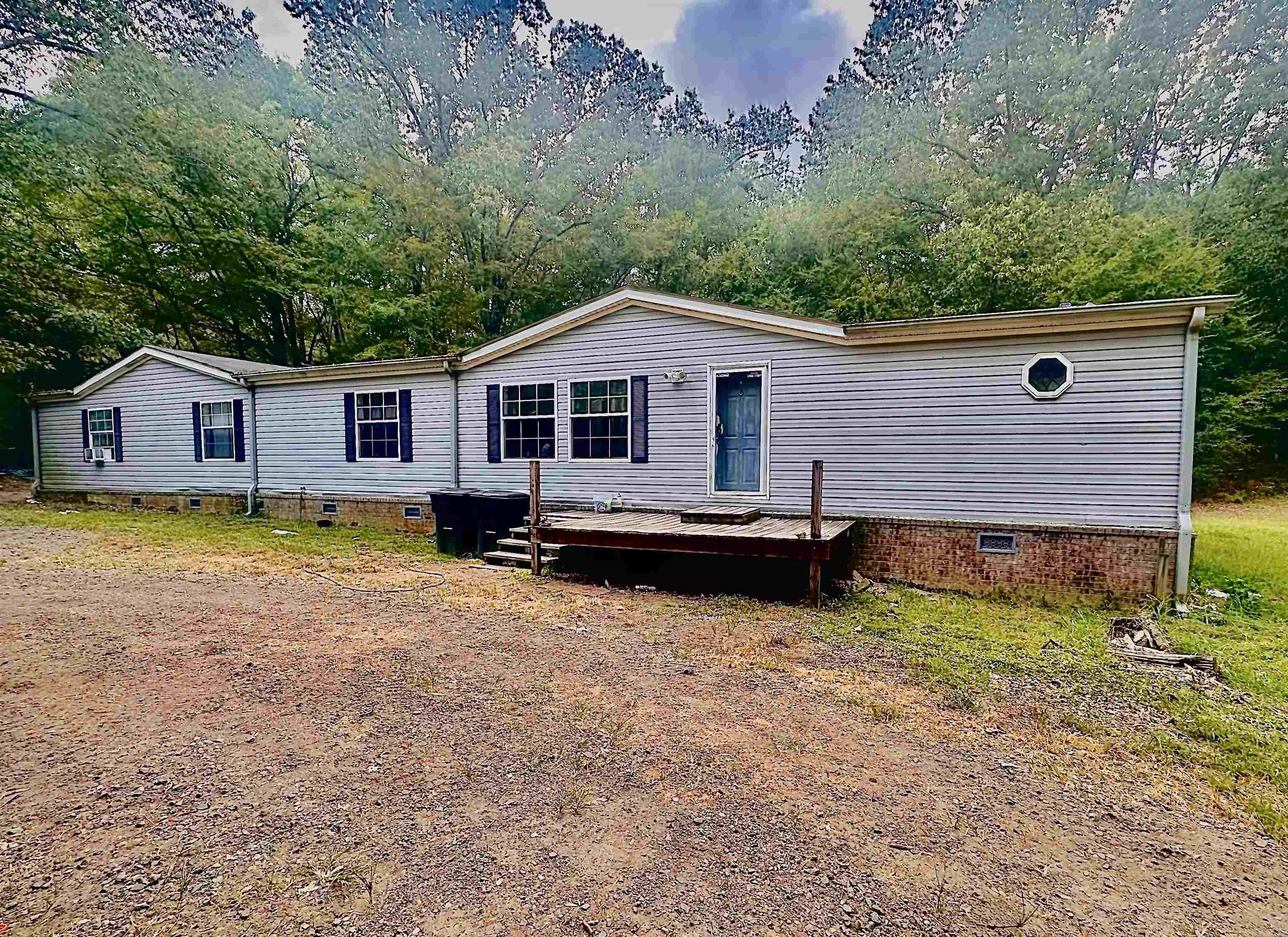 This large mobile home sits on 5 acres, offering plenty of space to enjoy the outdoors and create the lifestyle you’ve been looking for. The property includes a storm shelter, a storage shed, and even comes with a deep freezer, washer, and dryer that will stay with the home. The house itself needs some TLC, but with your vision and updates, it could become a great hunting camp or full-time residence. Outdoor enthusiasts will love the location—just minutes from the river with excellent opportunities for hunting and fishing right at your doorstep. If you’ve been searching for a property with space, potential, and a great location, this is it!