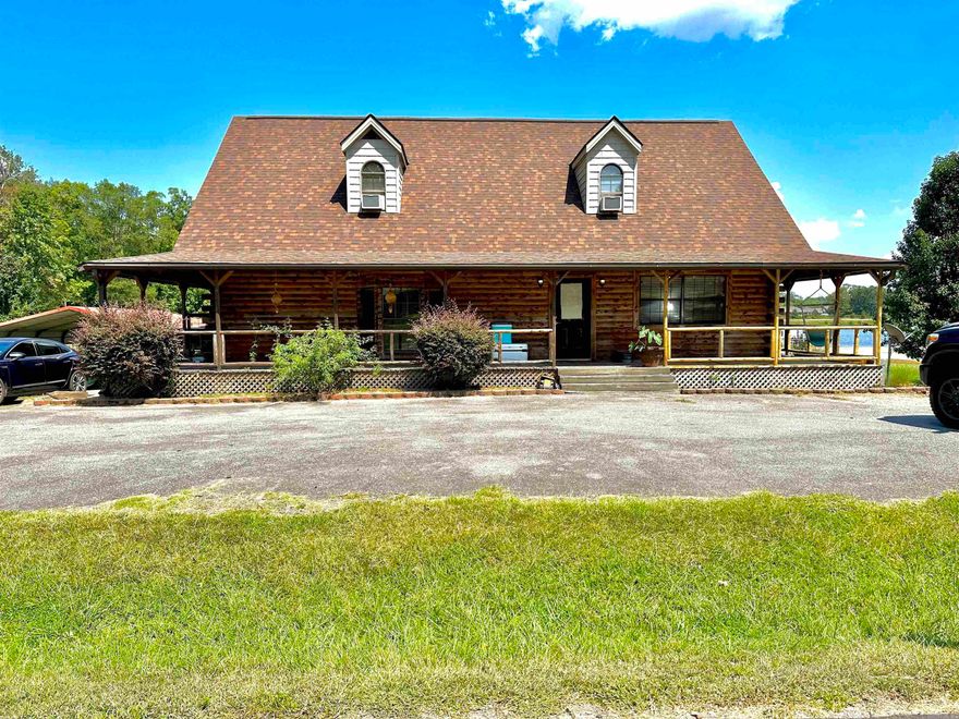 Nestled in the heart of White Hall School District, this charming log cabin offers rustic character with thoughtful touches throughout. A striking spiral staircase crafted from cedar serves as the centerpiece of the home. The home features spacious bathrooms both upstairs and in the master suite, each thoughtfully designed with a walk-in shower and a stand-alone soaking tub. All closets throughout the home are impressively large, providing ample storage without sacrificing style or space. Step outside to enjoy a spacious wraparound porch, while taking in all of the peaceful surroundings. The generous backyard is fully fenced, providing both privacy and room to roam, and the back porch offers a serene view overlooking a large private pond just beyond the property line. While the pond is not included in the sale, it adds to the tranquil setting that makes this home feel like a retreat. For added convenience, the property includes two separate two-car carports and is within walking distance of Gandy Elementary School. This is a rare opportunity to enjoy the charm of country living with the benefits of an established neighborhood!