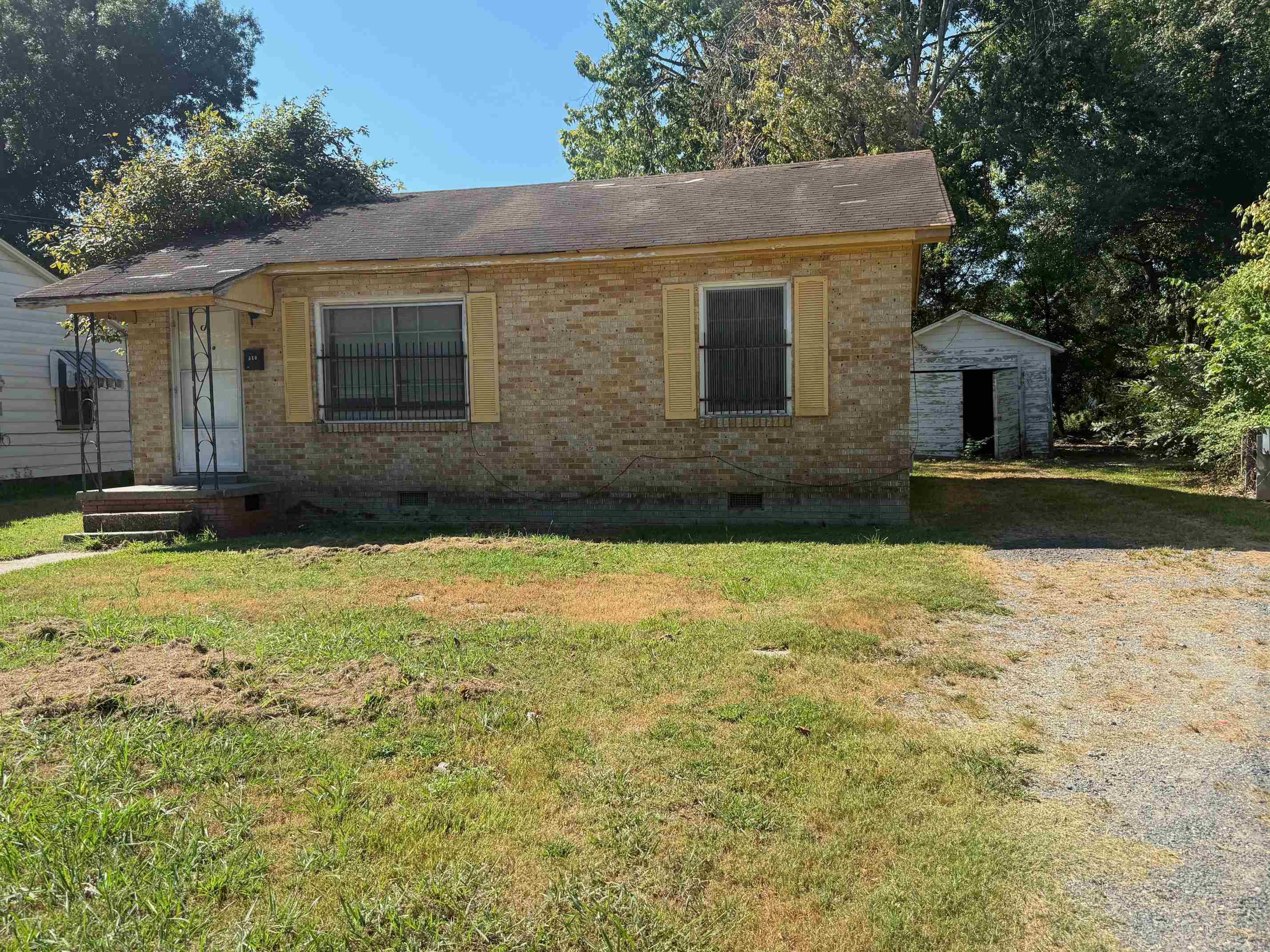 All brick home with two bedrooms and one full bath. Eat-in kitchen. New interior painting, strong air conditioning. New interior door handles. The interior wood floors seem solid and will need reconditioning. Older roof but no leaks. Solid home overall that needs revitalizing from its next ownerās personal touch. Great purchase for a first-time buyer or investment property. Just the right size home to renovate or update with very low cost. Outbuilding needs some work but would be good for extra storage and lawn care items. Property is being sold as-is; where-is with no Seller repairs.