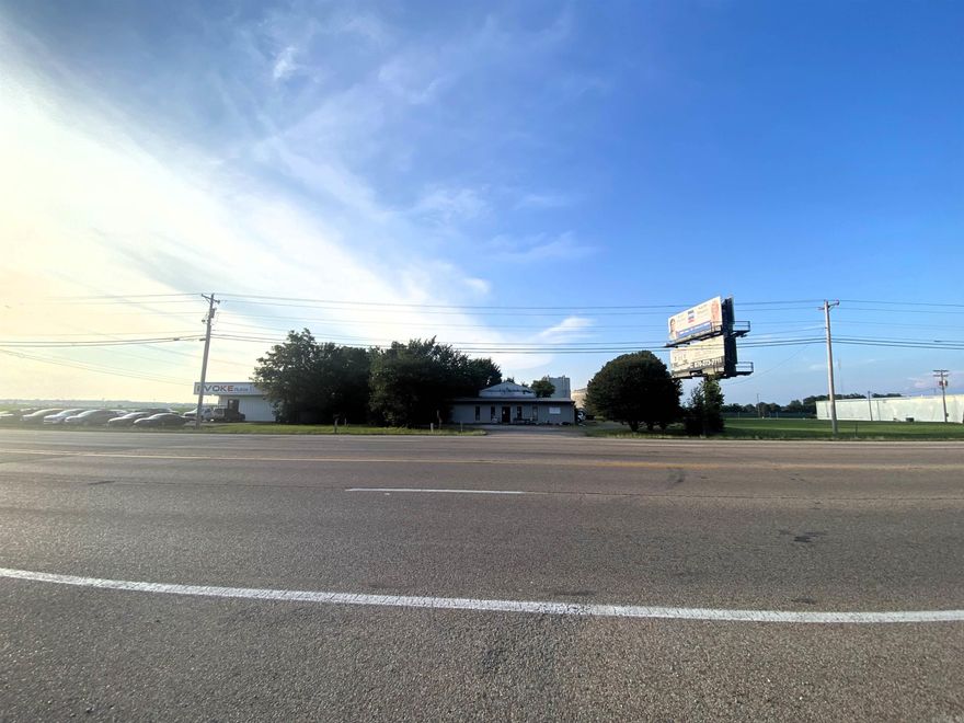 1.88 +/- acre lot with a building and workshop, zoned C-3. Almost 200' highway 18 frontage. Located near the corner of DR MLK JR Drive. Building has been used in the past as Retail/Service, but C-3 allows for a variety of opportunities. The main building consists of two parts - a heated/cooled metal structure around 60' wide by 25' deep. Attached to that is a warehouse style block building structure with tall ceilings, overhead doors and dock. The other structure on the land is believed to be about 80' wide by 24' deep workshop. Has CWL water and electric. Main building has a half bath, plus apartment area with mini kitchen with space for stove and refrigerator, and a shower area.