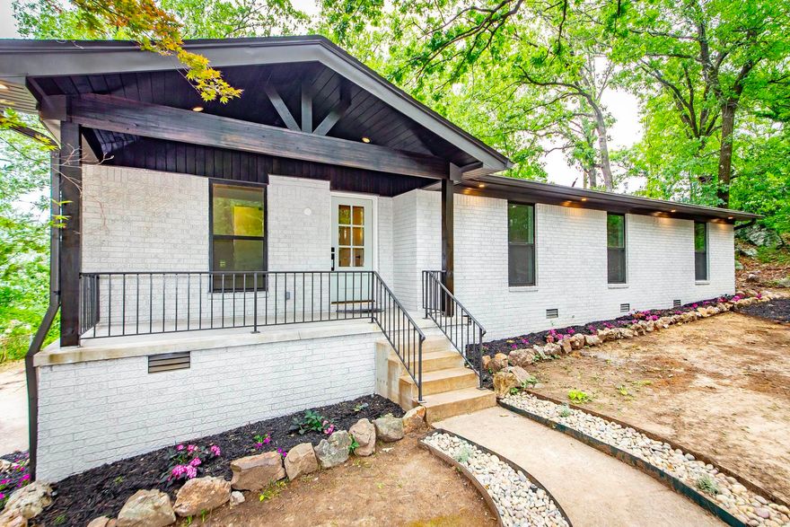 Welcome to 9008 Leatrice Drive—a beautifully remodeled ranch-style retreat set on nearly a full acre in the heart of West Little Rock. From the moment you arrive, you'll notice the thoughtful details: fresh landscaping, vaulted porch entry, and a canopy of mature trees. Step inside to soaring vaulted ceilings and a bright, open layout perfect for entertaining or relaxing. The kitchen is a true showstopper with  slim shaker cabinetry, stainless steel appliances, a huge walk-in pantry with acacia butcher block counters. The home features 4 spacious bedrooms, 2.5 stylish bathrooms, and a layout that flows seamlessly to the outdoors. Enjoy breathtaking views from the double-decker deck—ideal for morning coffee or unforgettable sunset evenings. The 2-car garage includes workshop space for hobbies or extra storage. This home offers rare privacy and views, all within easy reach of city conveniences.