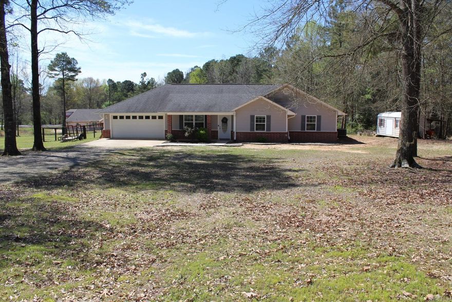 3 BR, 2 full baths, approx.1670 Sq. Ft. of living space situated on approx. 2.31 acres of country living.  Central A/C & Heat 2 car attached garage.  Fully fenced.