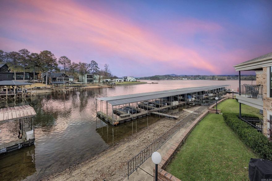 Nestled within the prestigious, wooded shores of Lake Hamilton, the highly sought-after Sculley Pointe community. This exclusive and rarely available lakefront condominium offers the perfect blend of luxury, privacy, and convenience—just minutes from the finest dining, shopping, and entertainment that Hot Springs has to offer. Designed for effortless lake living, this beautifully updated, move-in-ready residence features private access to your covered boat dock and private stairs leading directly to your grilling area and boat slip. Enjoy breathtaking year-round lake views, stunning sunsets, and abundant natural light throughout the home. Offering three bedrooms, two full bathrooms, and a versatile flex space within one of the bedrooms, the thoughtfully designed floor plan provides both comfort and functionality. Extensive recent upgrades include new windows, updated flooring, granite countertops in the kitchen and bathrooms, upgraded lighting, plumbing fixtures, ceiling fans, and a storm door. Additional improvements include hot water heater, refrigerator, wine cooler, stackable washer and dryer, Sony Bravia TV, updated faceplates & electrical and, AC Condenser.  WELCOME HOME!
