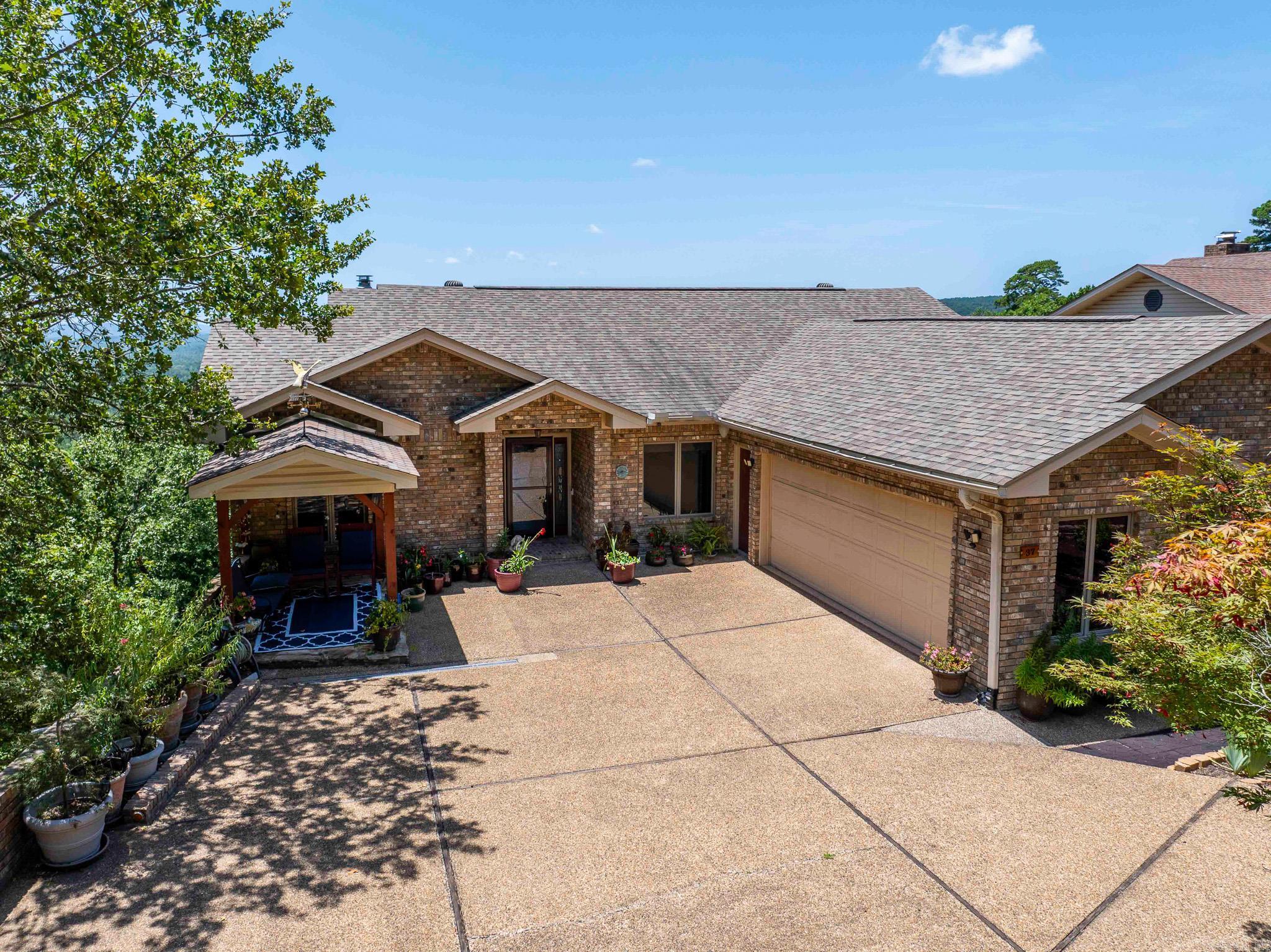 You will be on top of the world ....this recently remodeled 4 bedroom 4 bath home offers breathtaking views, gourmet kitchen, 6 different decks plus a front entry gazebo to enjoy and room for all your friends and family. Entry level hosts primary suite and guest bedroom, wonderful open great room with fireplace, newly restructured kitchen, formal dining area, roomy pantry/laundry area. Lower level will delight you with an additional kitchen, living area, hobby room and secondary primary suite with steam shower. Enormous closet with oodles of storage. Quality with a capital "Q". Hot Springs Village Property Owner Association has a new member buy-in fee of $2,000.00 due and collected at closing.