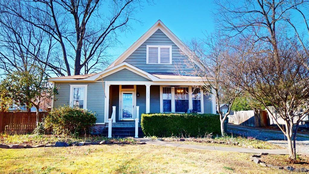 Charming Craftsman home in Conway's Historic District. As you walk into this 3 bed/1 bath home you are greeted w/ an oversized living room w/ corner fireplace stove, lovely refinished hardwood floors, & gorgeous vintage chandeliers hanging from tall ceilings. Formal dining will take your breath away as your eye is drawn up to beautiful chandelier hanging from reclaimed wood ceilings. Through the dining room, you'll find a completely updated Kitchen. Updates include countertops, cabinets, stainless steel appliances, gas stove, sink & hardware, & pleasing color pallet. Through the kitchen, you'll find an updated butler pantry with tons of storage space & Laundry area. 2 bedrooms & 1 bath are on one side of the house through a hallway off the kitchen. A third bedroom is near the front of the house & would make a perfect home office. New HVAC unit (2023). New luxury vinyl in guest bedrooms, hall and bathroom. Covered front porch makes for the perfect place to rock on a porch swing. Back yard is a dream with covered back porch, extra landscaping, storage shed w/electricity, fully fenced w/gates on both sides of this corner lot. Agents see remarks for more details.