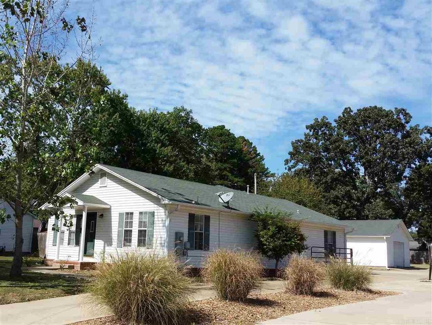 Pretty as a picture, neat and clean. Remodeled and up to date kitchen and newly remodeled master bath. Big living room with arched doorway to kitchen area. Formal dining room as well as a movable island for breakfast bar. Refrigerator stays. Nice in ground storm cellar just off back door. Huge covered back patio with paved area for parking.  Nice shop w/overhead garage door for car storage or storage or workshop.