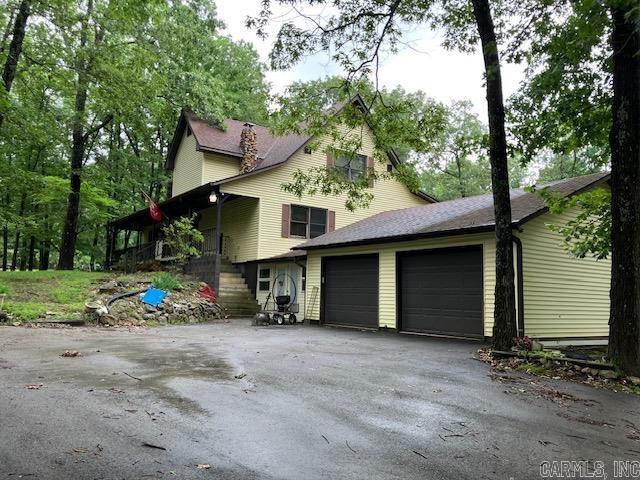 Nestled on just under 10 acres of land, this expansive two story home offers over 4,000 square feet of living space and is located less than one mile from Pocahontas, AR. Surrounded by beautiful oak timber, the property features two ponds, a shop with several outbuildings and a very private setting. The house boasts a spacious front porch, a two car garage, and a long driveway that enhances its secluded feel. Inside you will find ample room for family living, including a finished basement complete with its own kitchen, bathroom, living room and bedroom. A rare find with this much square footage and nice sized acreage, make this countryside retreat yours today!