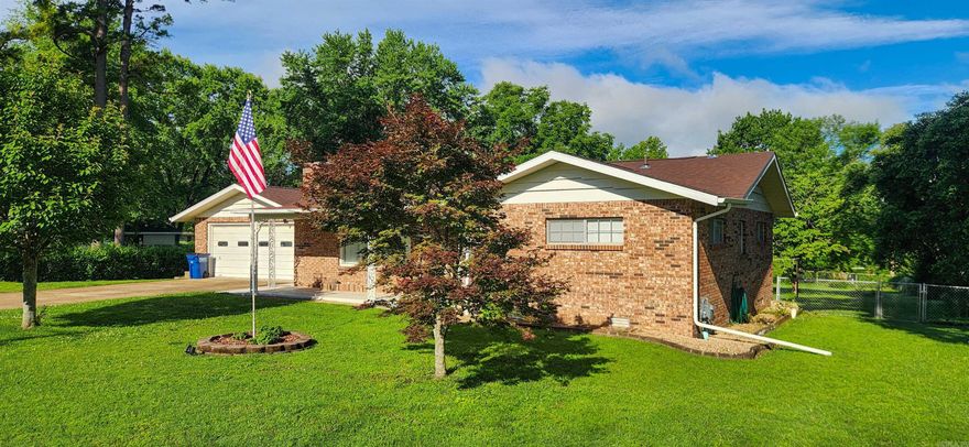 This charming 2-bedroom, 2.5-bath brick home is nestled on almost a full acre right in town! Enjoy a peaceful, parklike backyard setting surrounded by a chain link fence. Inside, you'll find newer laminate flooring throughout. The large living room features a beautiful brick fireplace. The oversized utility room and large 2-car garage with extra storage add everyday convenience. Recent updates include a new roof (2024), HVAC system and water heater (both approx. 2 years old). A backyard shed and appliances are included. Conveniently located close to everything, this well-maintained home is priced to sell!