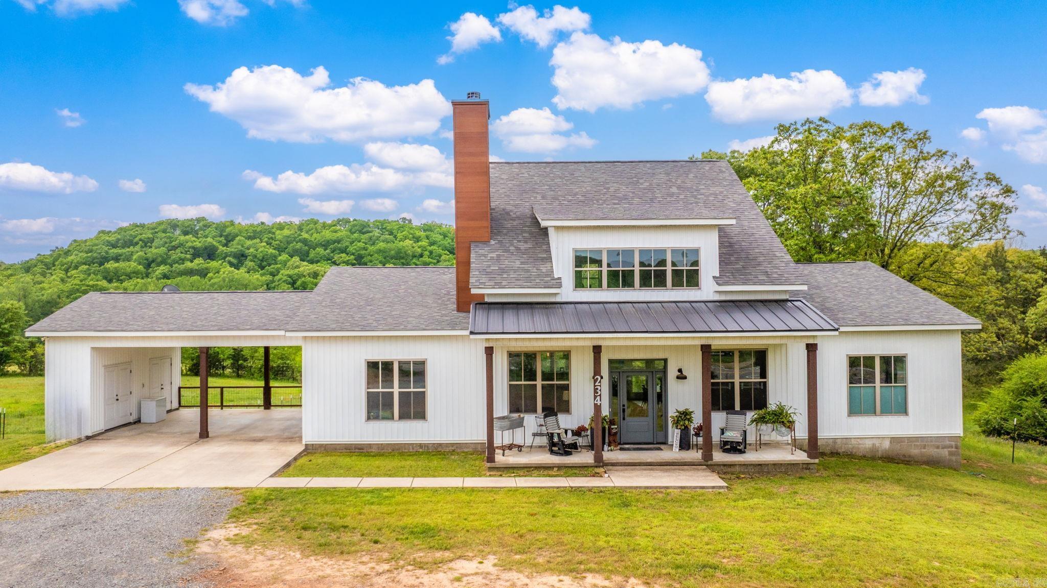 Modern farmhouse style meets peaceful country living on nearly 10 acres in Greenbrier! This 3 bed, 3 bath home offers 2,385 sq ft of open-concept living with soaring ceilings, a loft, and sleek industrial railings. The kitchen is a dream—white custom cabinets, an island, stainless appliances, double ovens, and huge picture window with a view. The living room features a stone fireplace with built-ins, and the spacious dining area sits beneath warm wood beams. You’ll love the walk-in pantry, large laundry room with butcher block counter, and stylish finishes throughout. Enjoy room to roam, garden, or just relax and take in the scenic setting. This one has it all—style, space, and privacy!