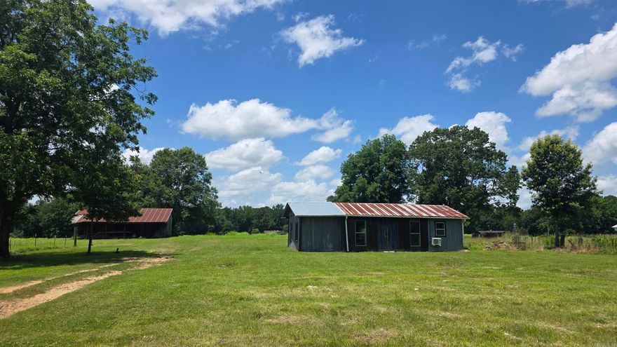 Do you want to downsize? Or have a very peaceful quiet place to go on the weekends? This cabin/tiny house has 800 square feet with 1 bedroom and 1 bathroom. There are 2 large barns and a carport sitting on 3.28 acres. It was built in 2023, all the wood used is Cypress! Sit on the back porch and enjoy life! Or delight in the homey feel of this cabin/tiny house! Enough land for free range chickens or maybe a horse or cow! Excellent garden spot just waiting for a gardener! Little River access is only 1.5 miles if you like to fish!