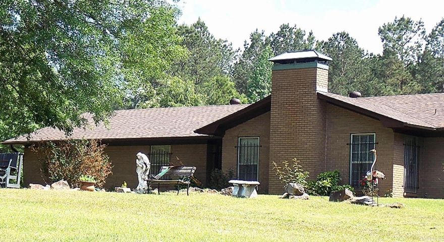 Welcome to this charming 1969 modern home, where vintage character meets contemporary comfort. Step inside to discover a sunken living room, beautiful beamed ceilings, and a cozy entryway nook. Enjoy meals in the inviting breakfast room or host elegant dinners in the formal dining room, complete with charming window bench seating.  The bathrooms feature stylish tile showers and half-tiled walls, while the updated kitchen boasts a new electric stove top, a separate oven, a sleek Samsung refrigerator, and a dishwasher.  With four spacious bedrooms, there's plenty of room for everyone. The property sits on beautifully landscaped acreage, and the fully fenced backyard is perfect for gatherings, complete with a hot tub pad and hookups. The large back deck is ideal for family fun and peaceful evenings.  If you're looking for tranquility, space for family gatherings, or even to start your own little farm, this home is your perfect match. Plus, you'll have convenient amenities nearby, including a fire department, a Dollar Tree, and a gas station, all less than a mile away.